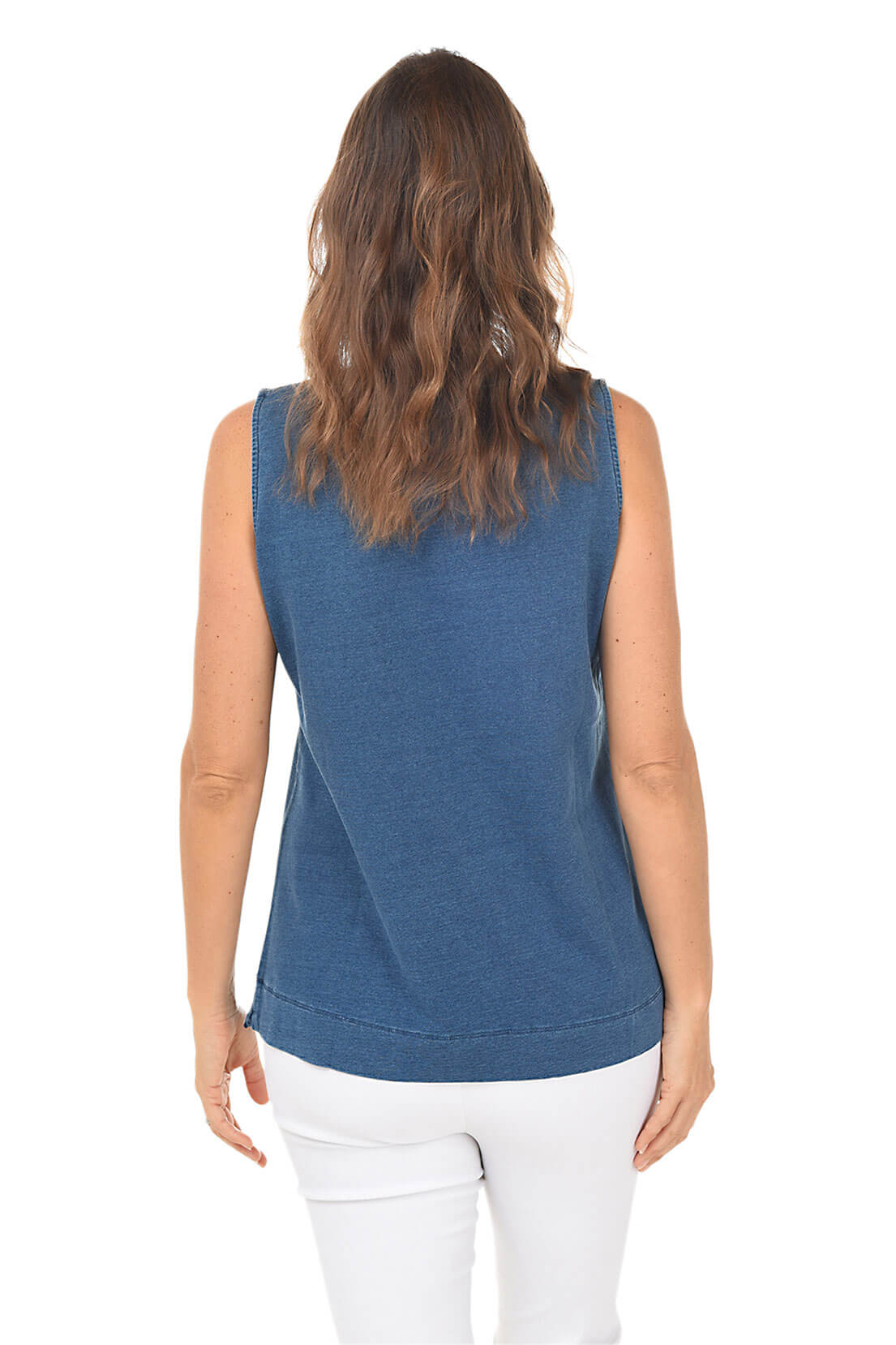 Woman wearing a blue sleeveless top and white pants on a white background. Back shot.