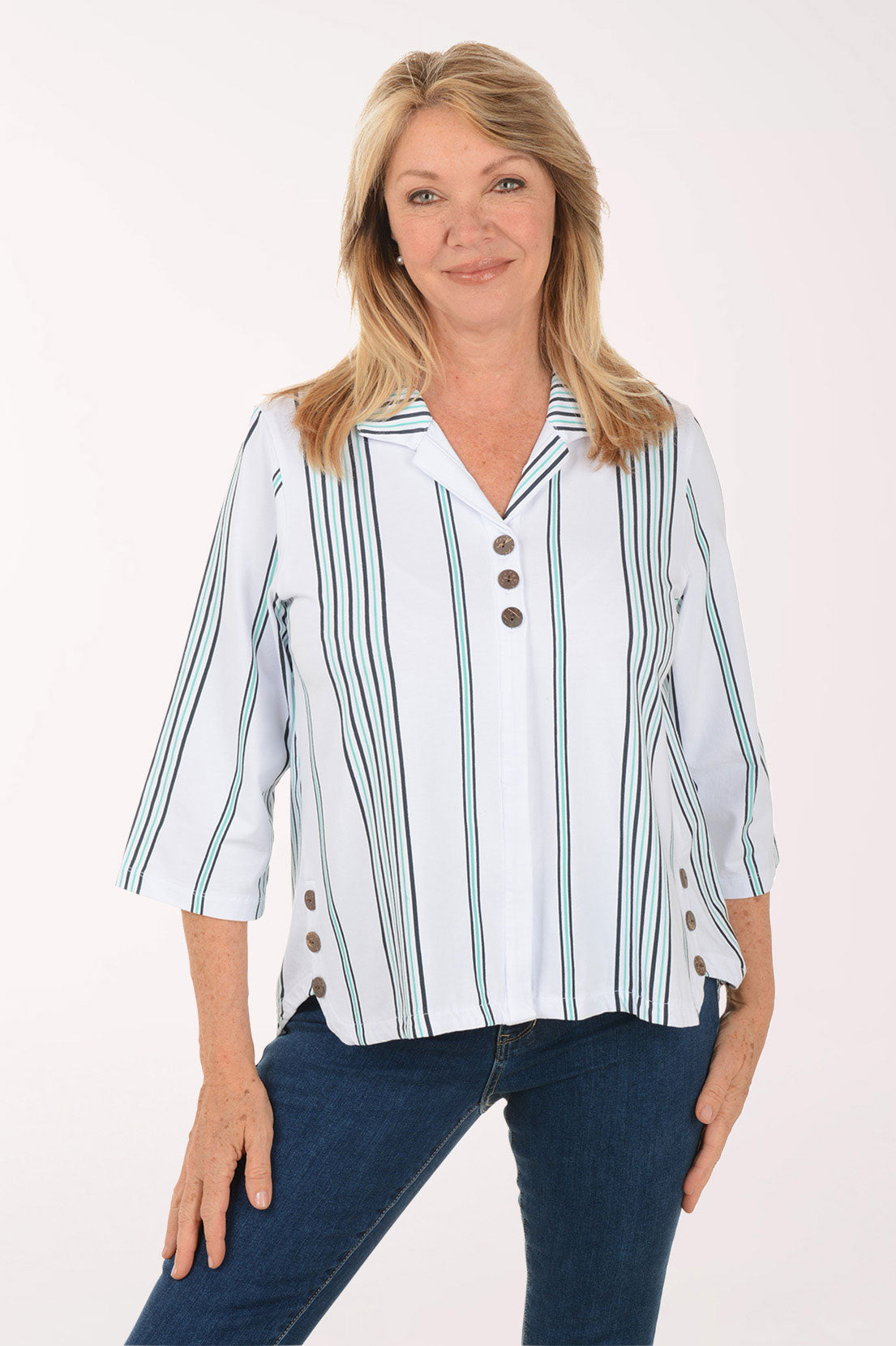Woman wearing a white blouse with green stripes and blue jeans on a white background
