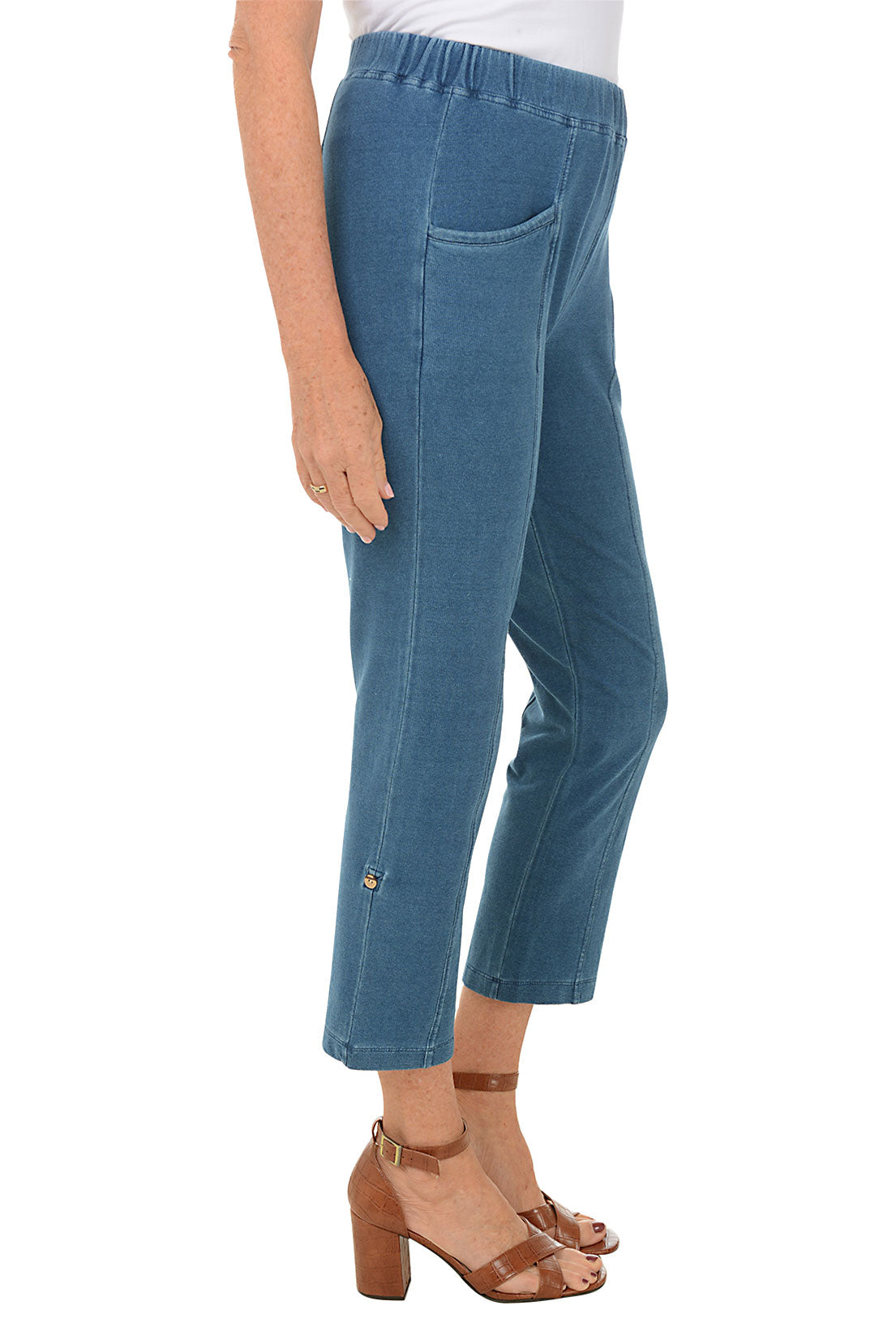 Blue jeans worn by a person on a white background. Side shot.