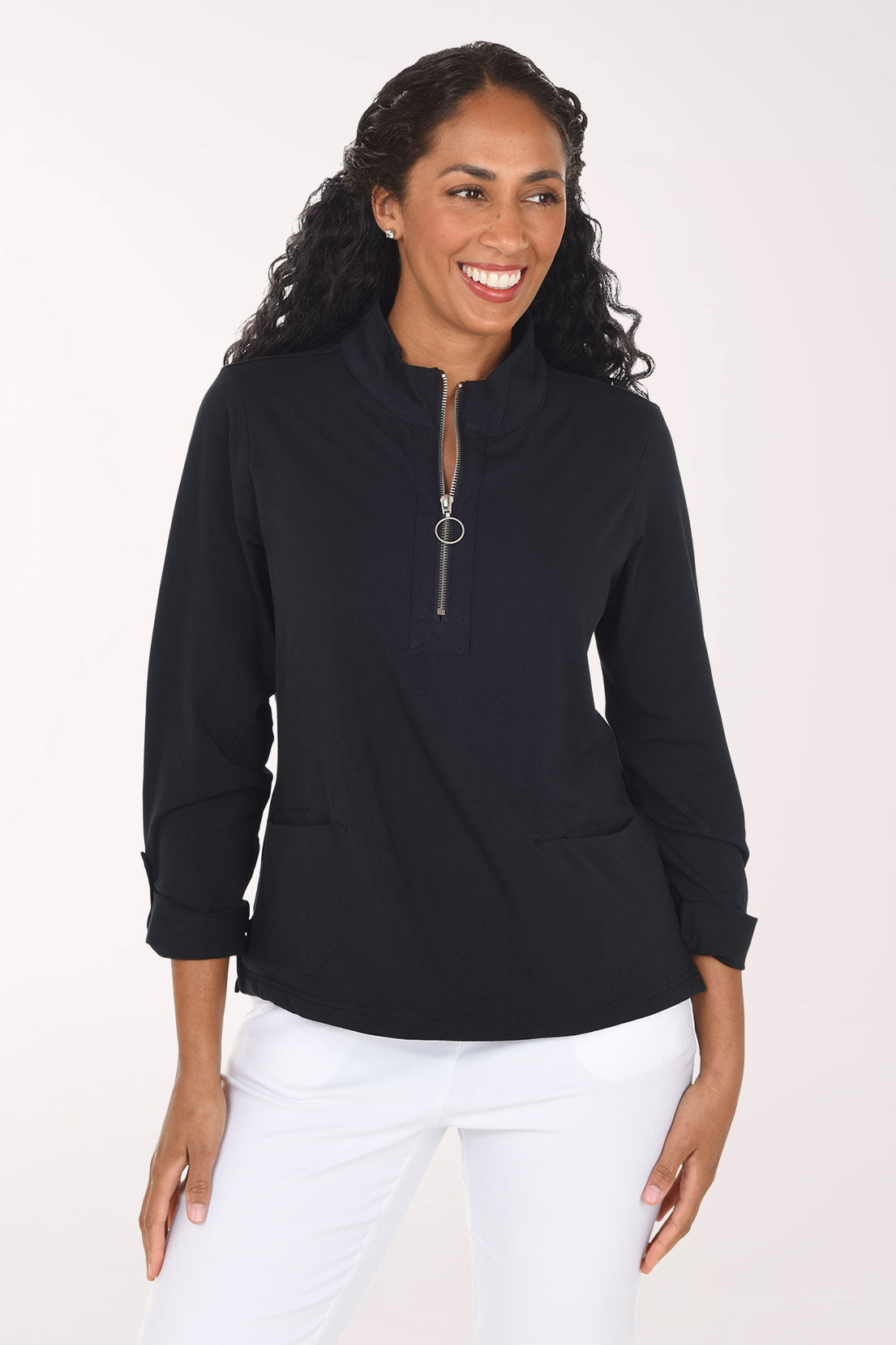 Woman wearing a black long sleeve half zip top