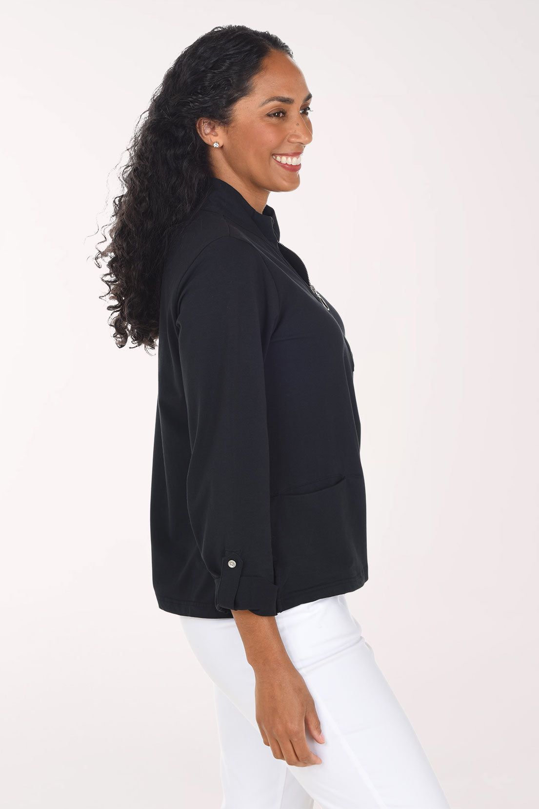 Woman wearing a black long sleeve half zip top