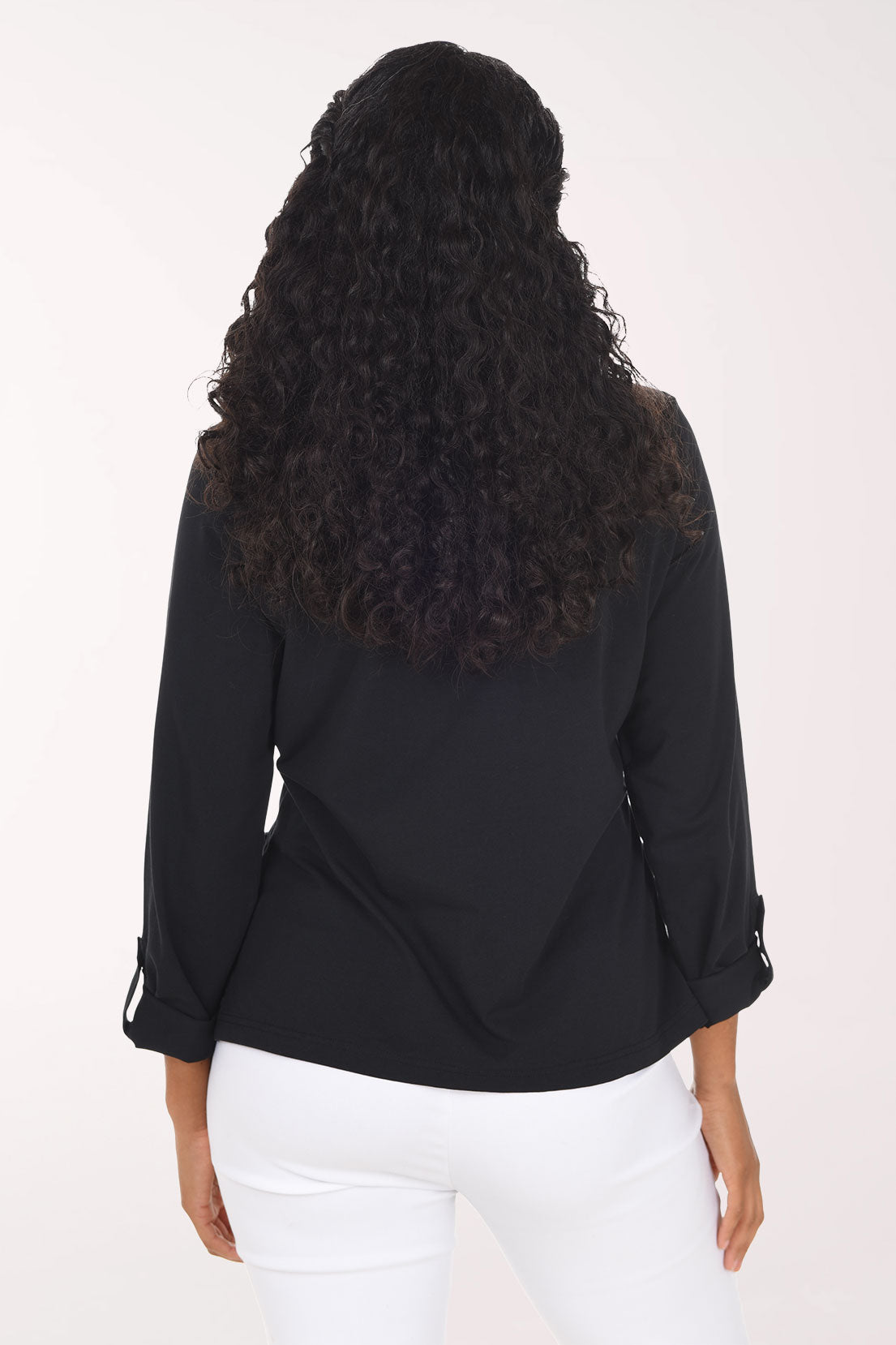 Woman wearing a black long sleeve half zip top