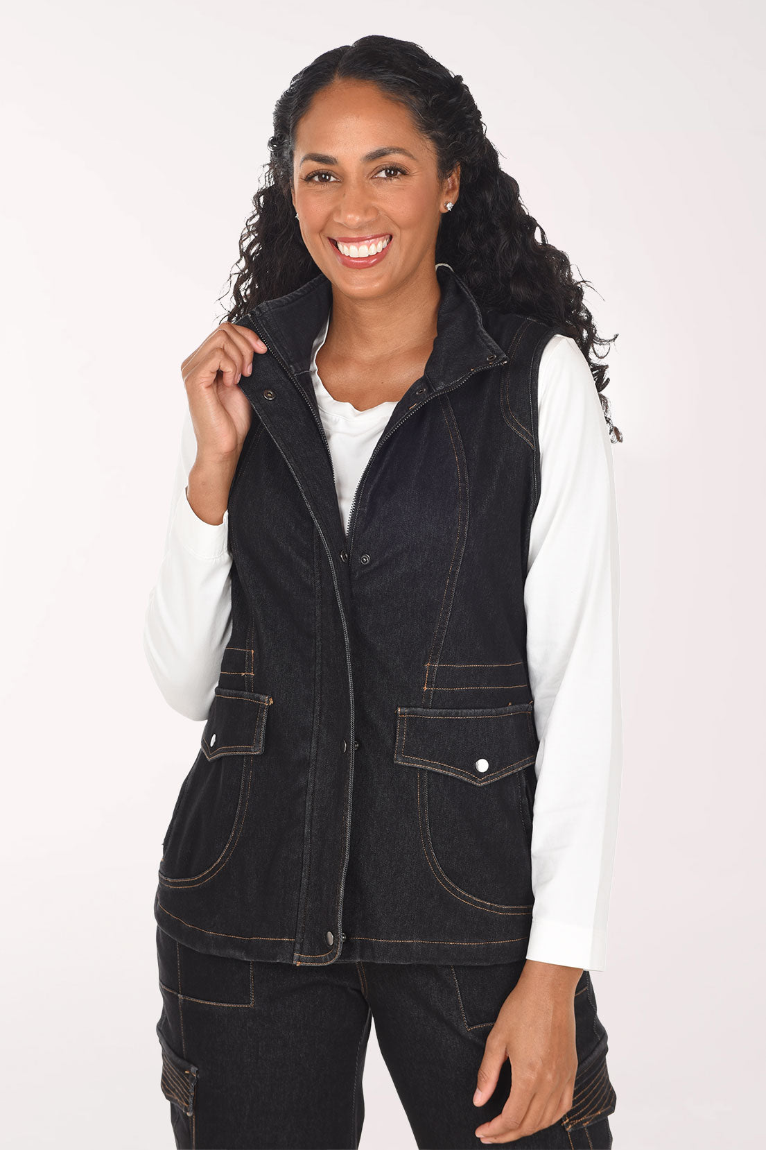 Woman wearing a sleeveless black denim vest