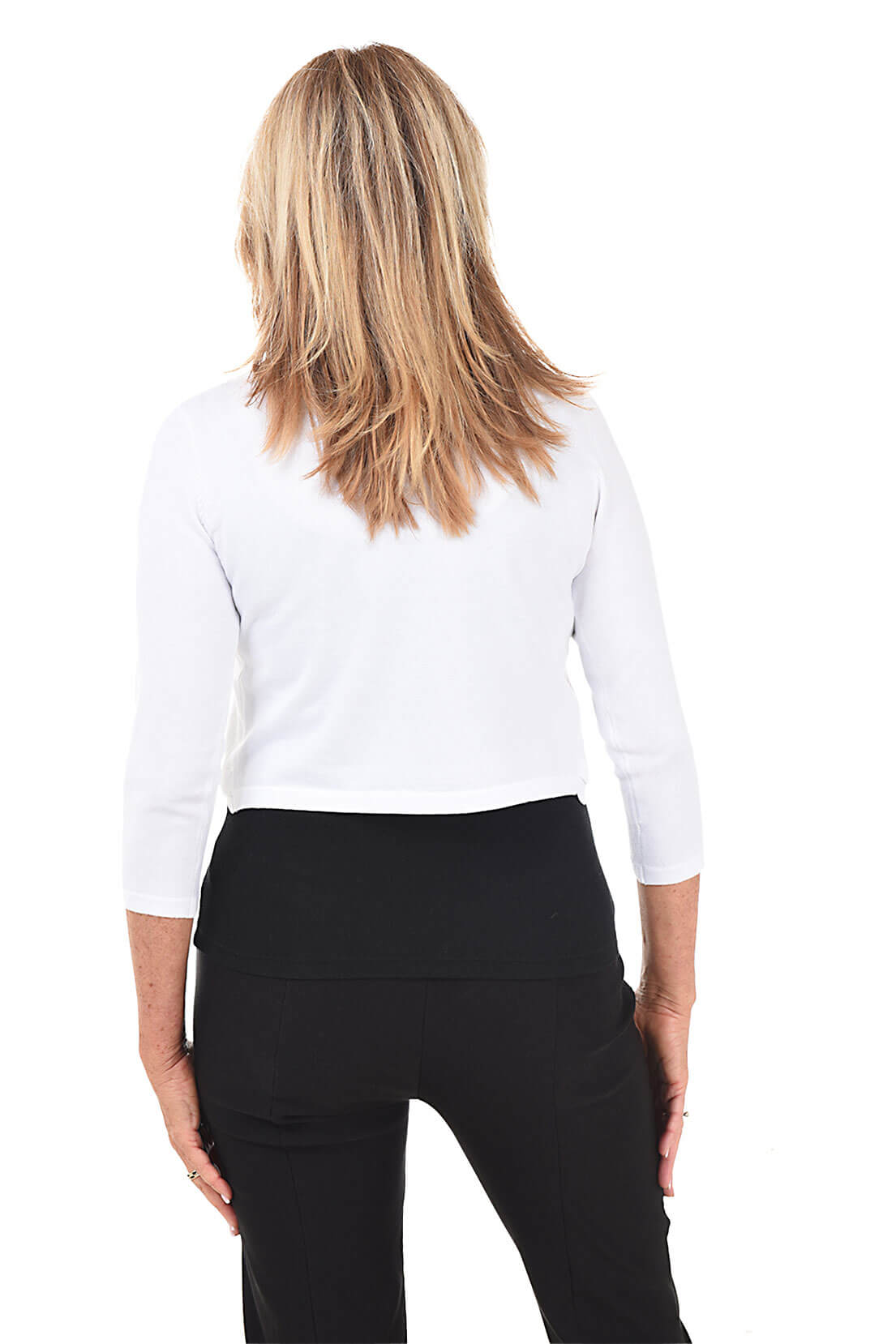 Person wearing a white long-sleeve top and black pants on a white background