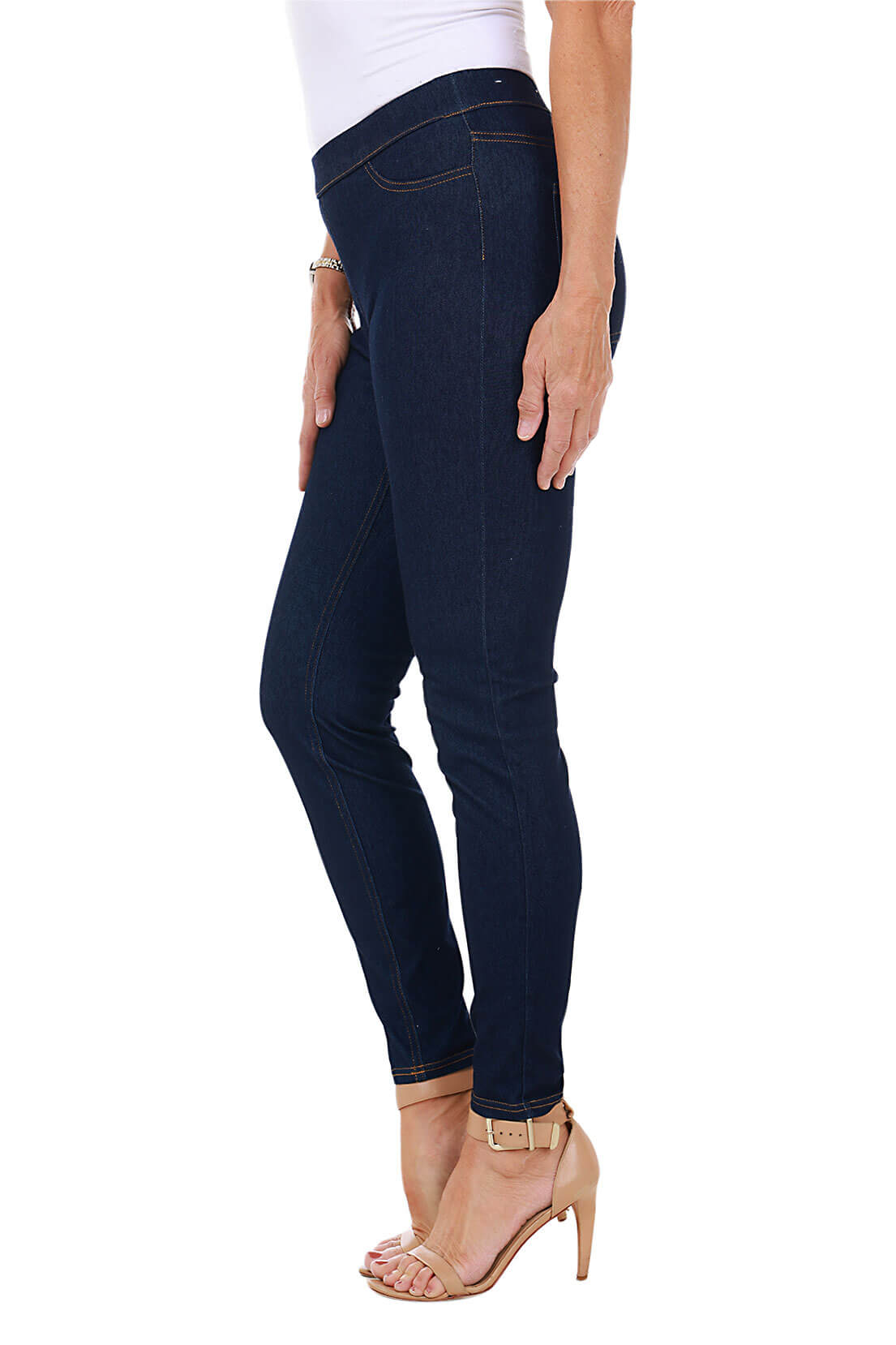 side shot dark blue jeggings worn by a person on a white background