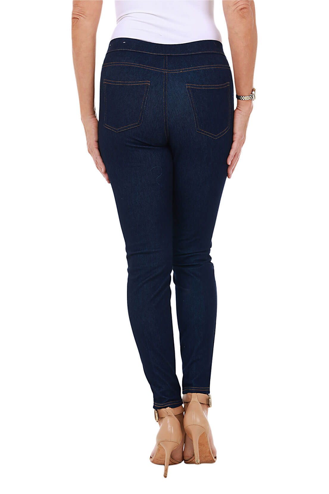a back shot of a model wearing dark blue jeggings on a white background
