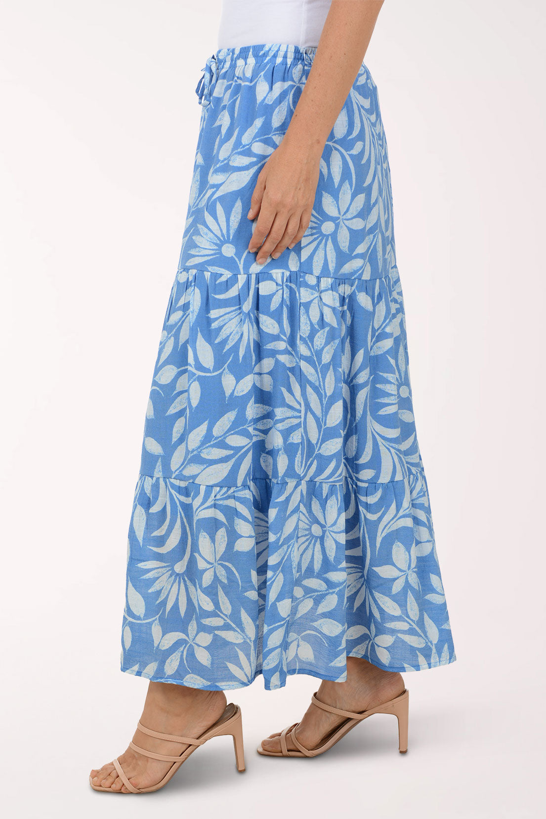 Blue floral skirt worn by a person on a white background
