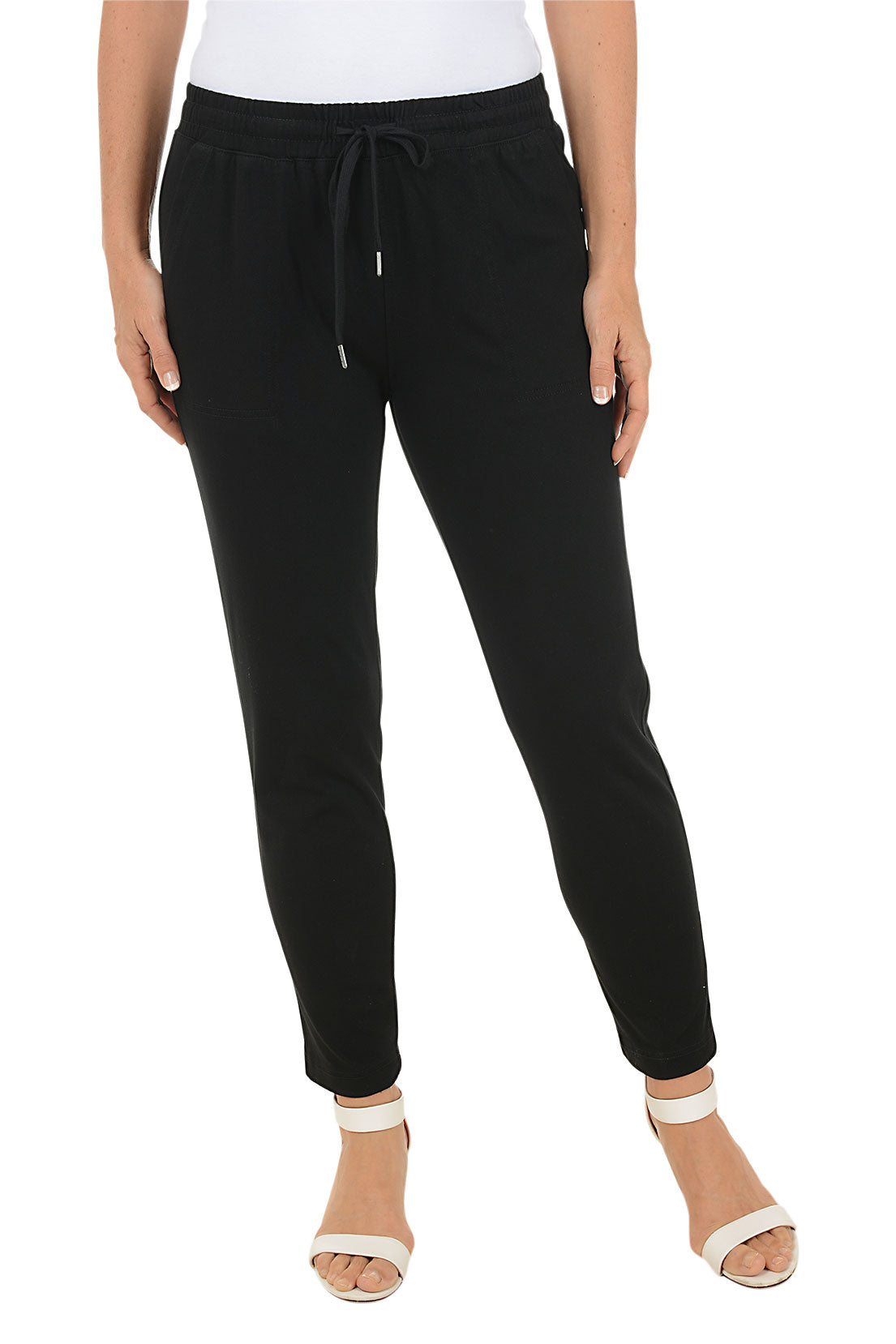 Black jogger pants worn by a person on a white background