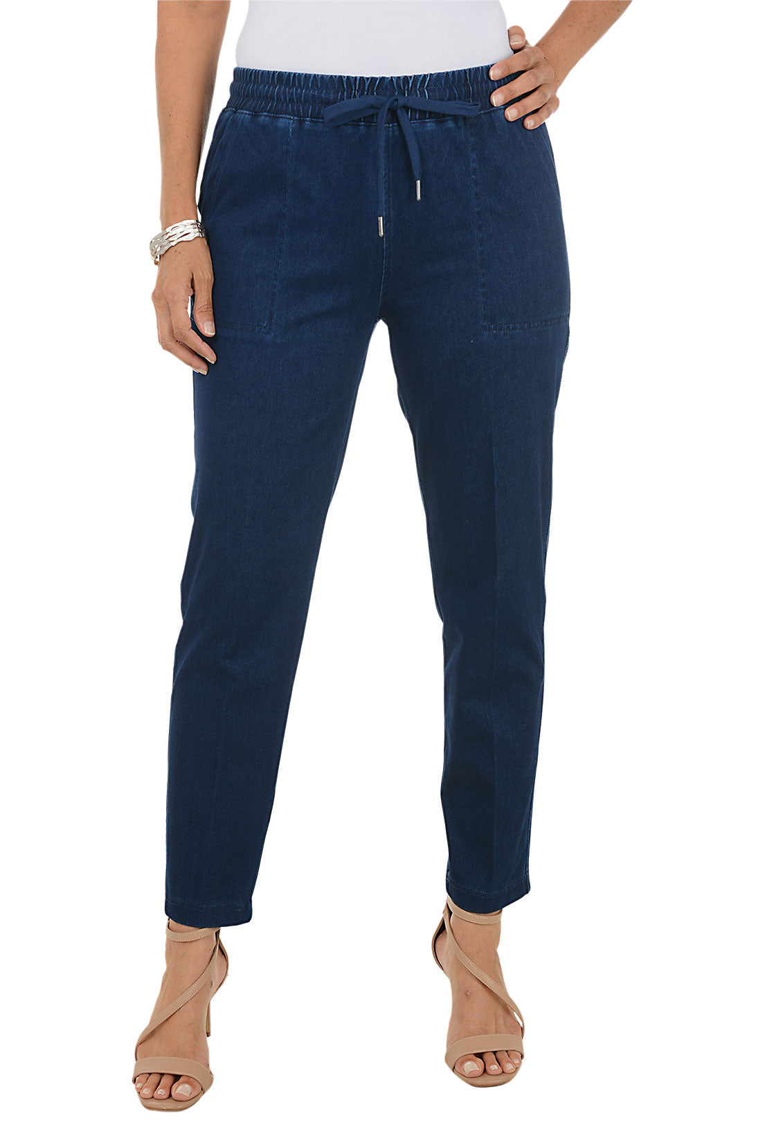 Dark blue wash jogger pants worn by a person on a white background