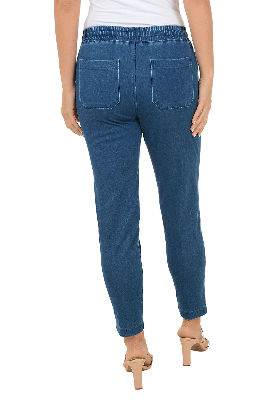 Blue jeans worn by a person on a white background. Back shot.
