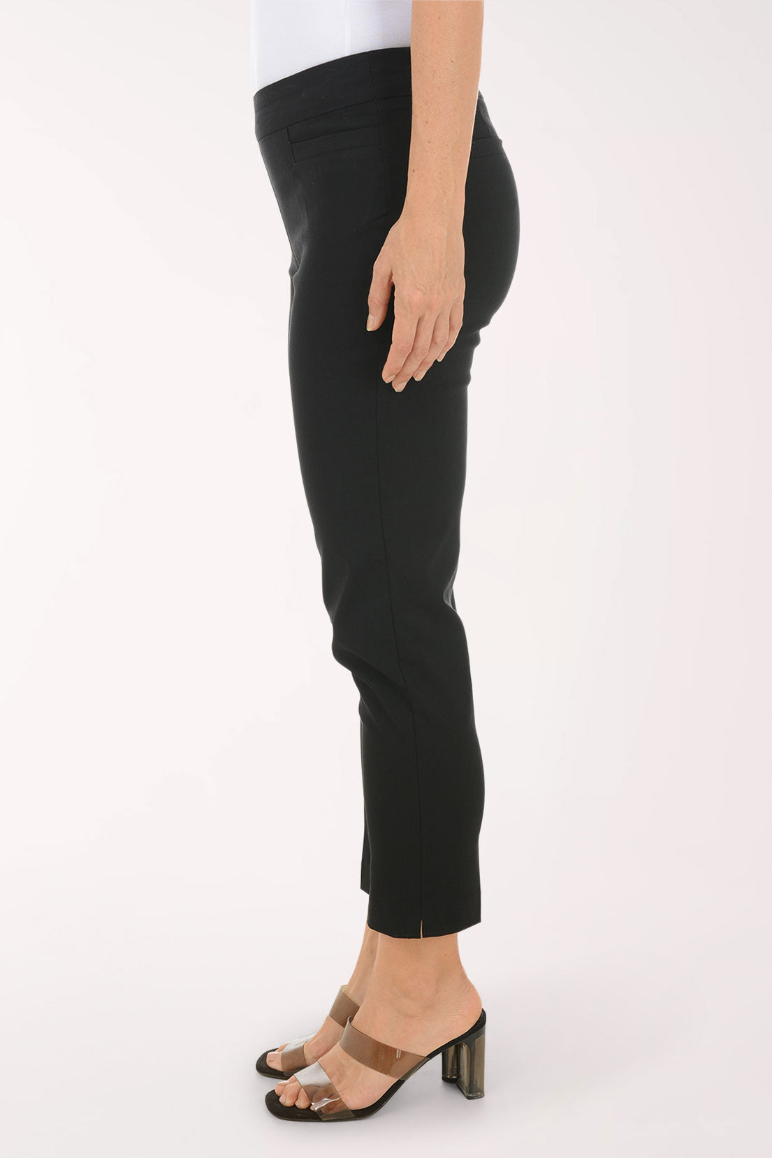 Person wearing black pants on a white background