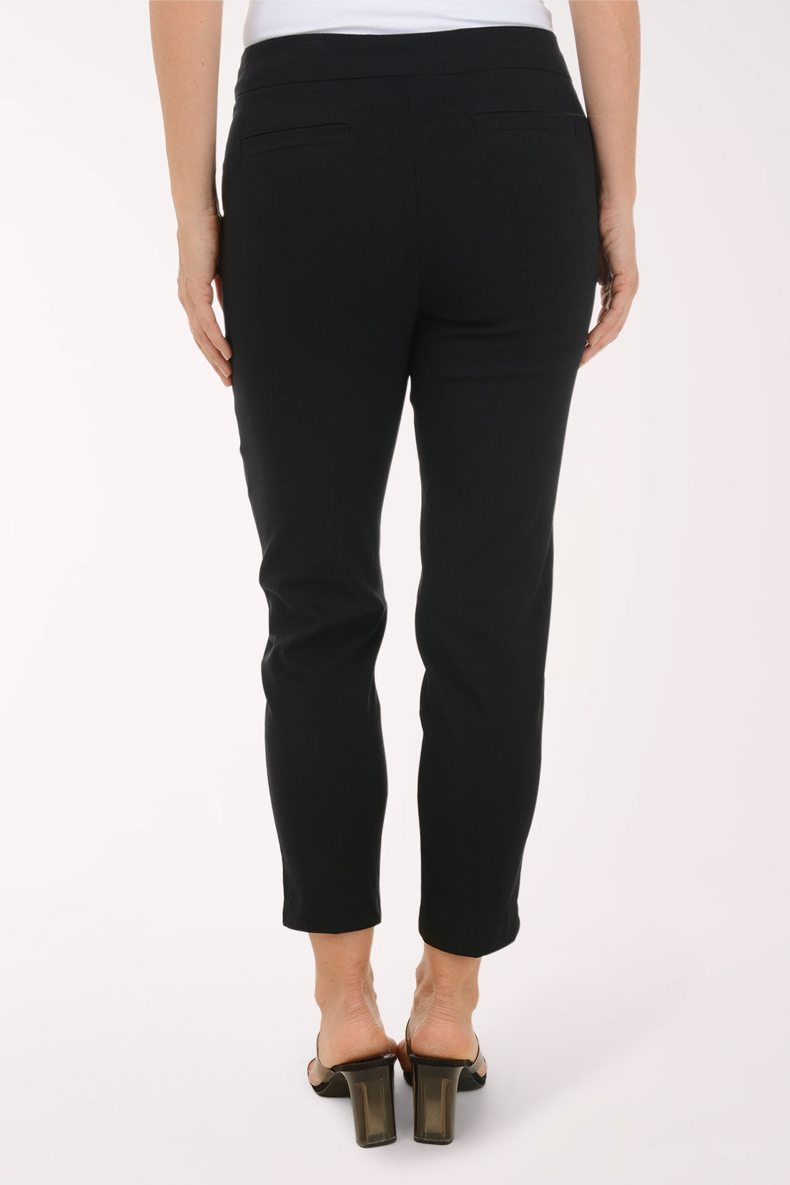 Person wearing black pants on a white background