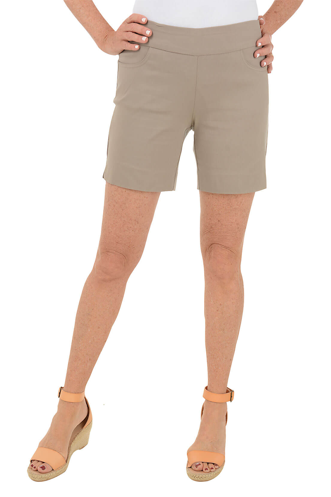 A front shot of a model pair of stone pull-on shorts with dual front pockets and side slits at the hemline.