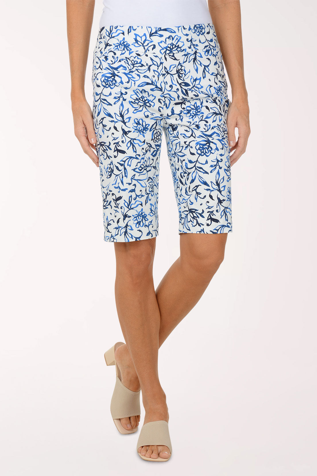 Person wearing blue floral shorts on a white background