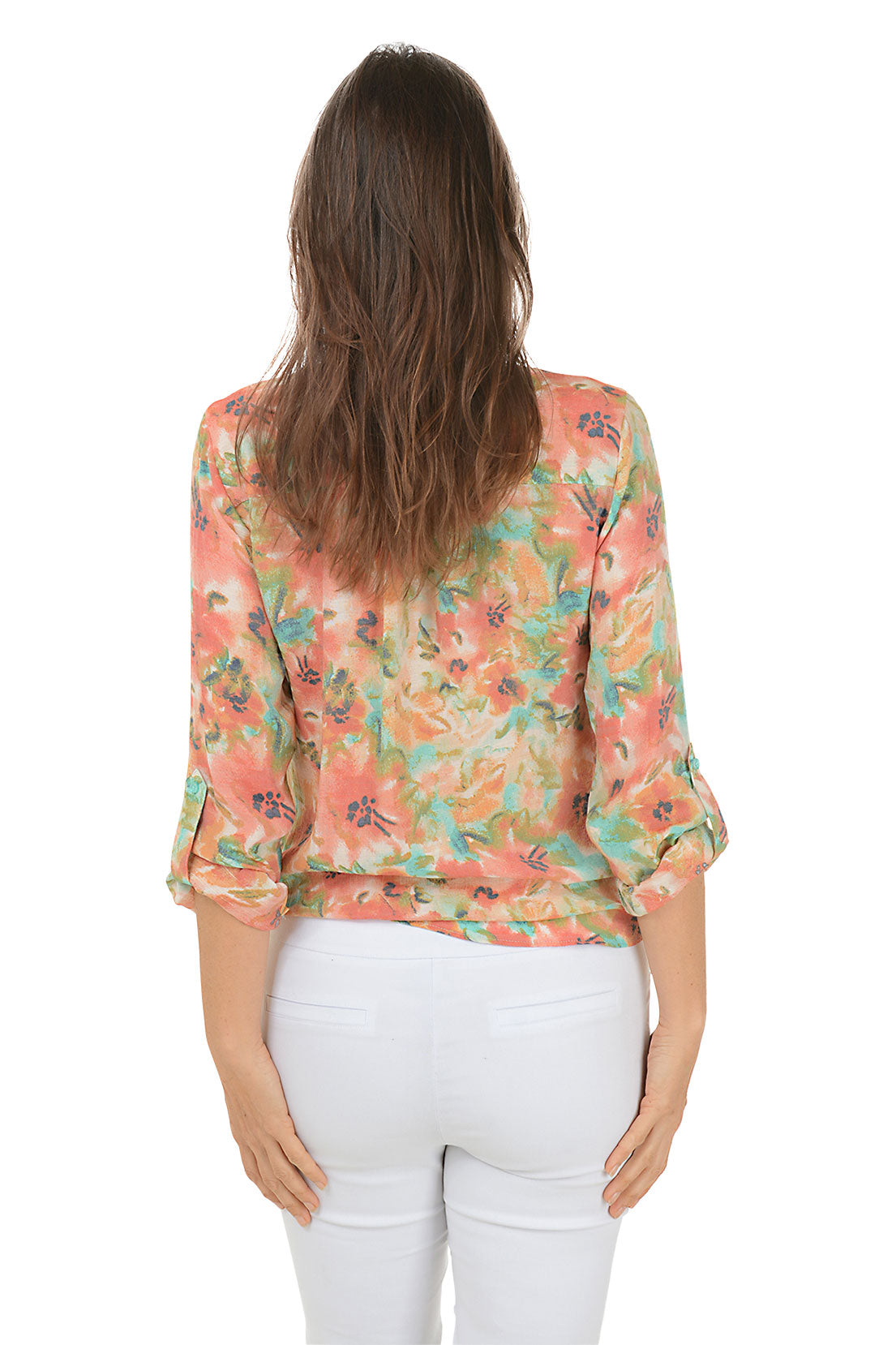 A back shot of a model wearing a floral button-front blouse with a mandarin collar and long sleeves, tied at the front, in a multi-color floral pattern.