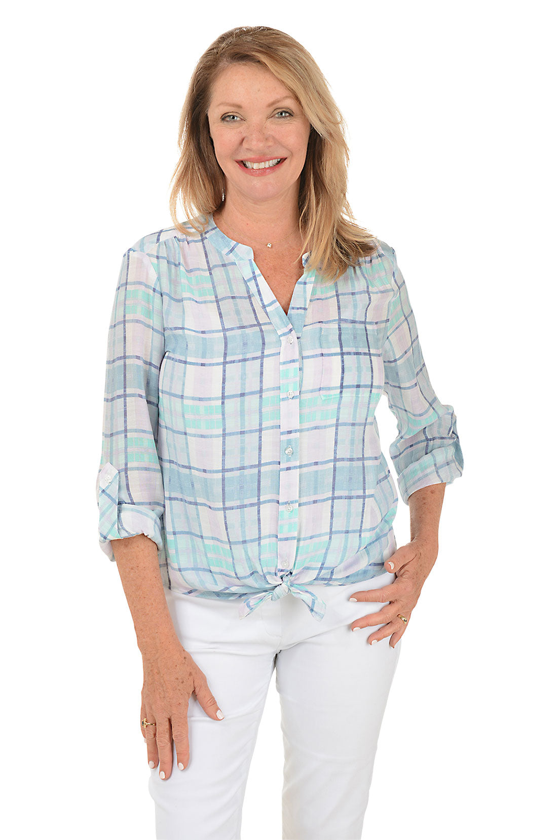 A front shot of a model wearing a blue and white plaid button-front blouse with a mandarin collar and long sleeves, paired with white pants.