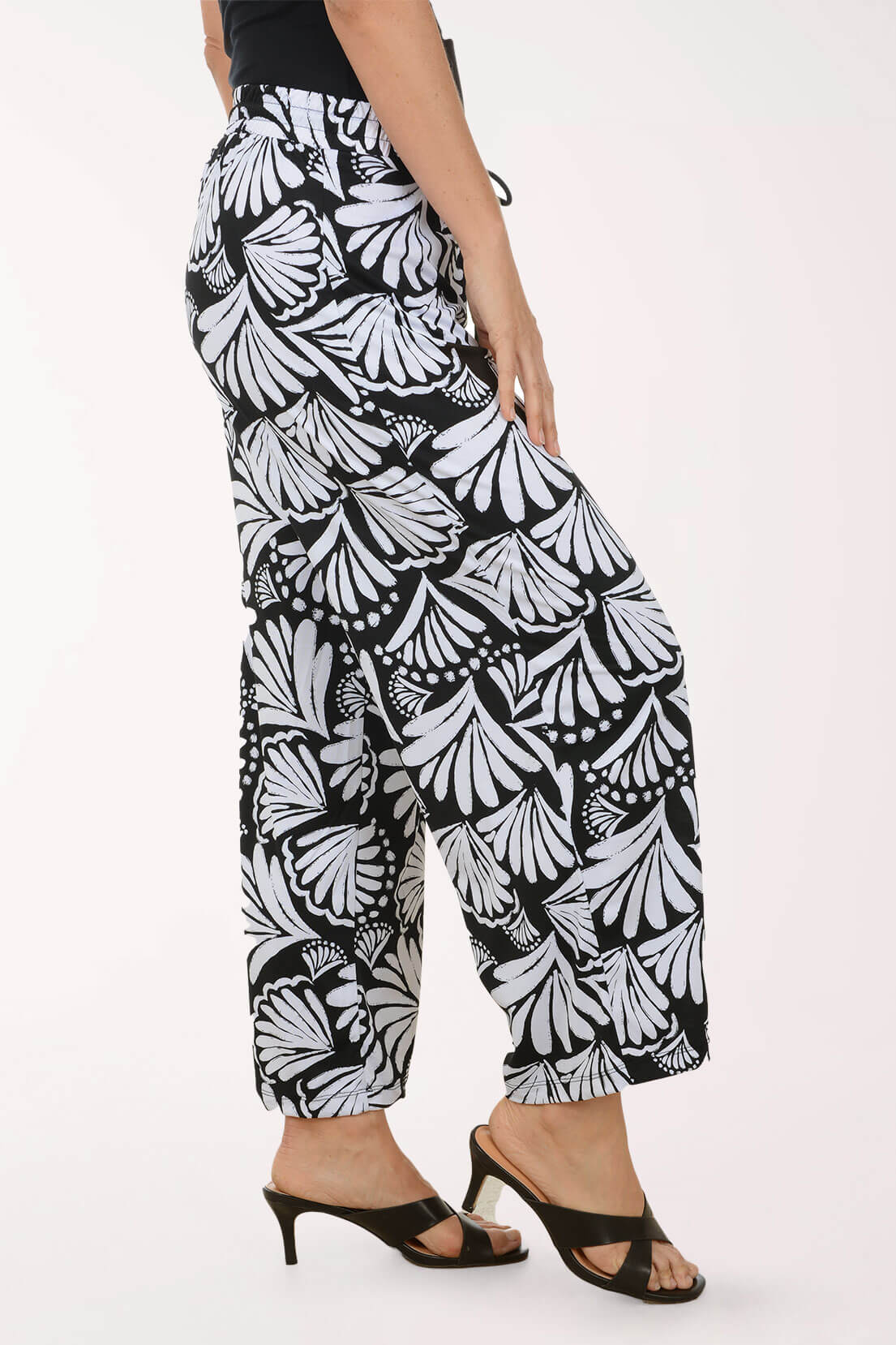Black and white patterned pants worn by a person on a white background