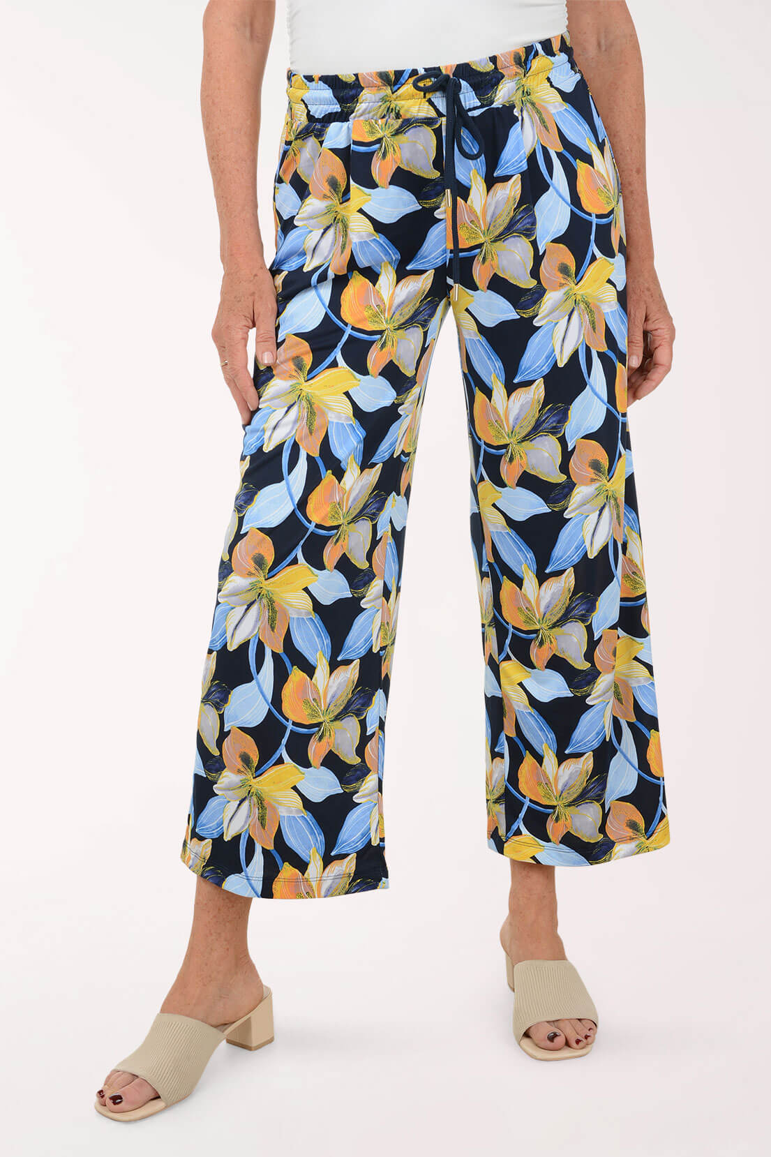 Floral-patterned pants worn by a person on a white background