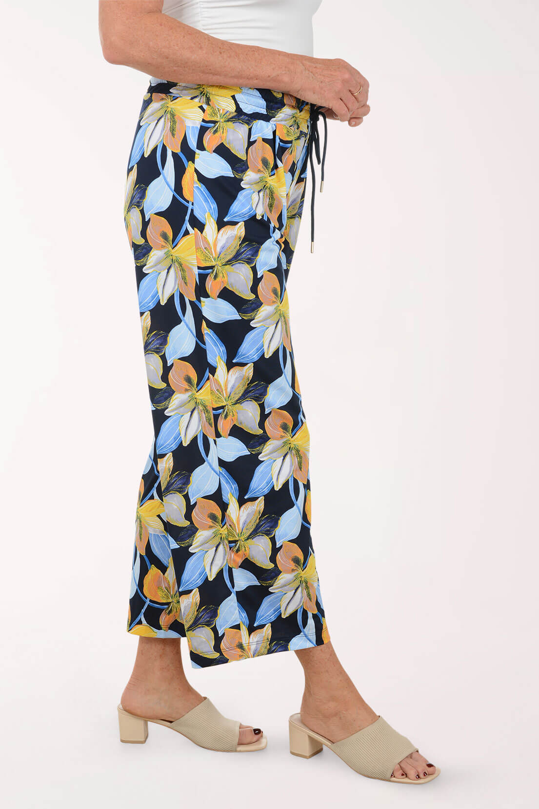 Woman wearing floral pants on a white background