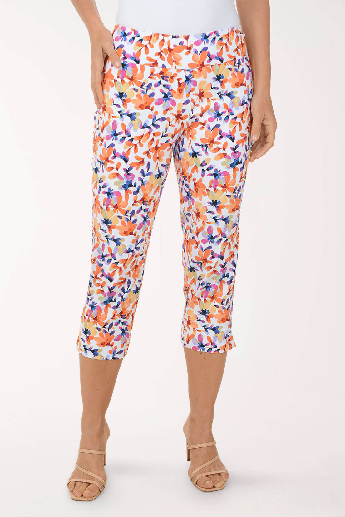 Multicolored floral capri pants worn by a person on a white background
