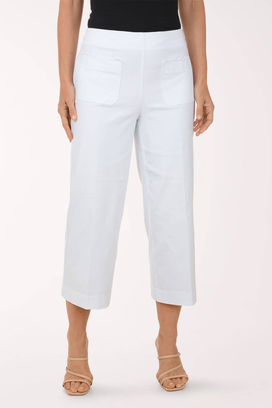 White pants worn by a person on a white background