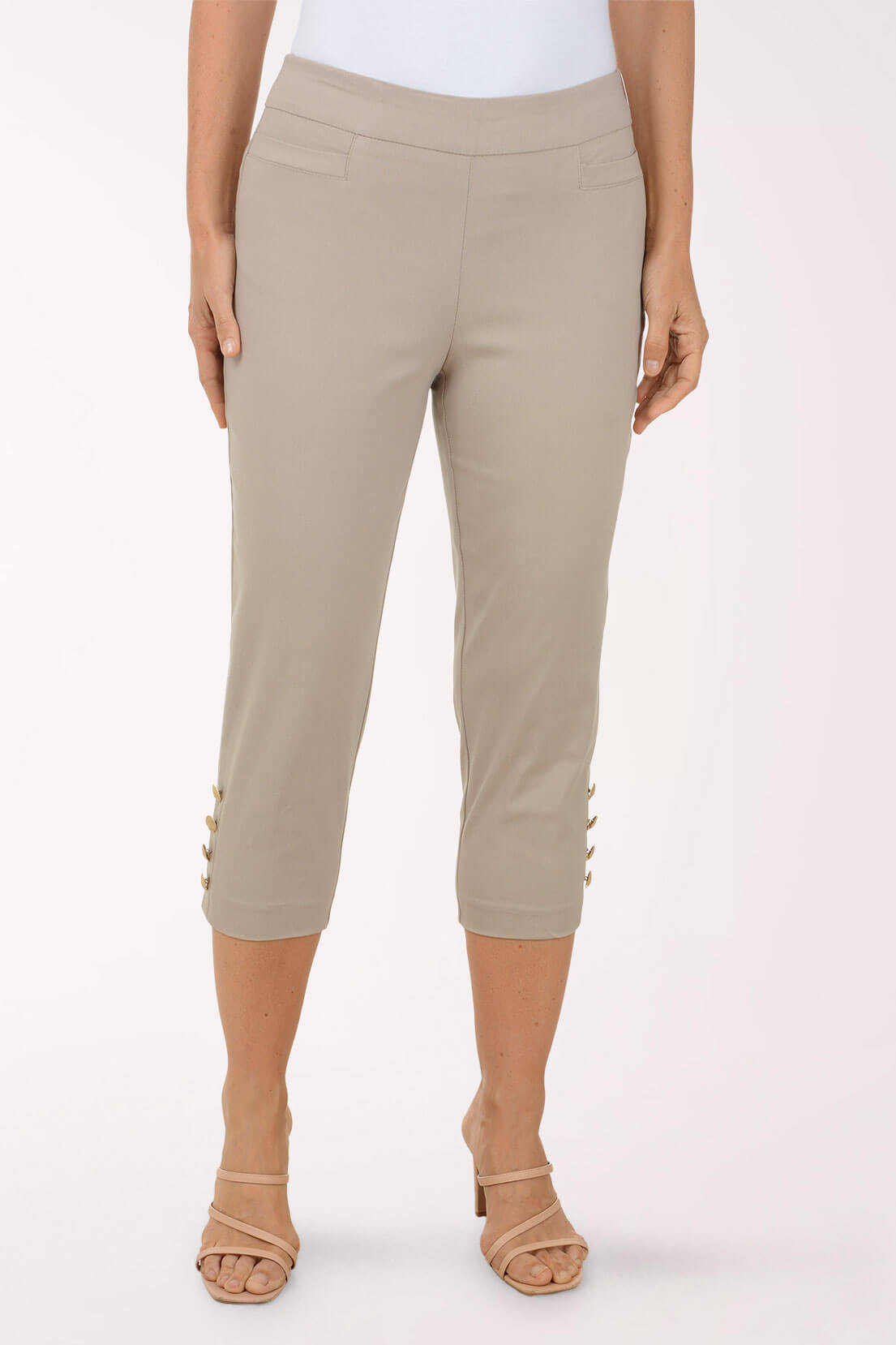 Beige capri pants worn by a person on a white background