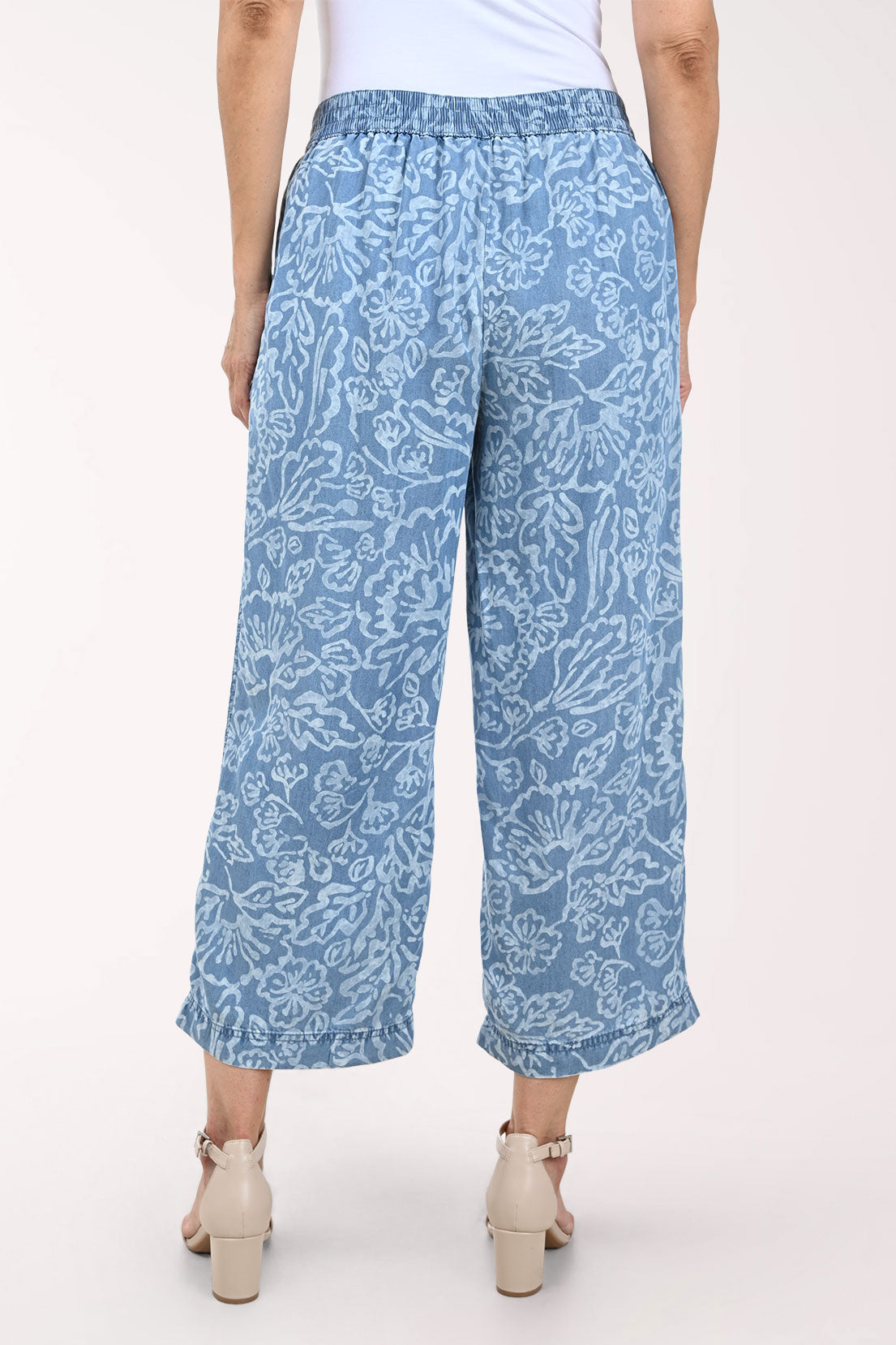 Woman wearing blue patterned pants on a white background