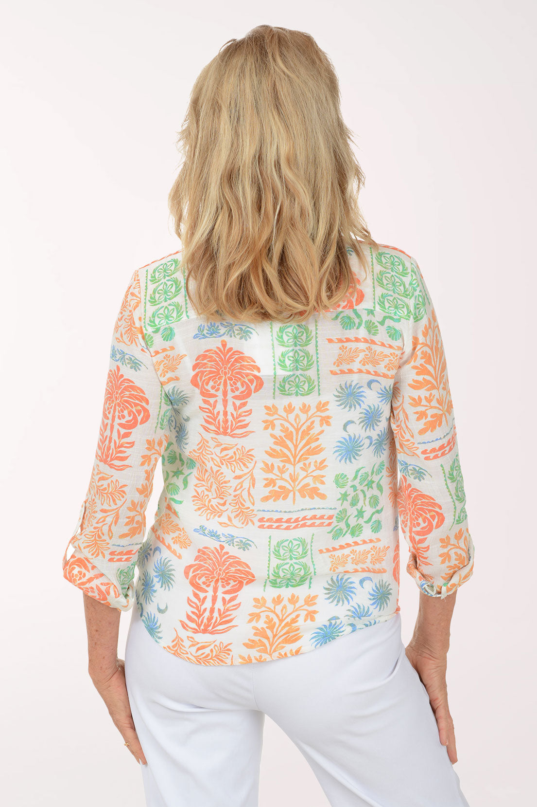 Woman wearing a colorful patterned shirt on a white background
