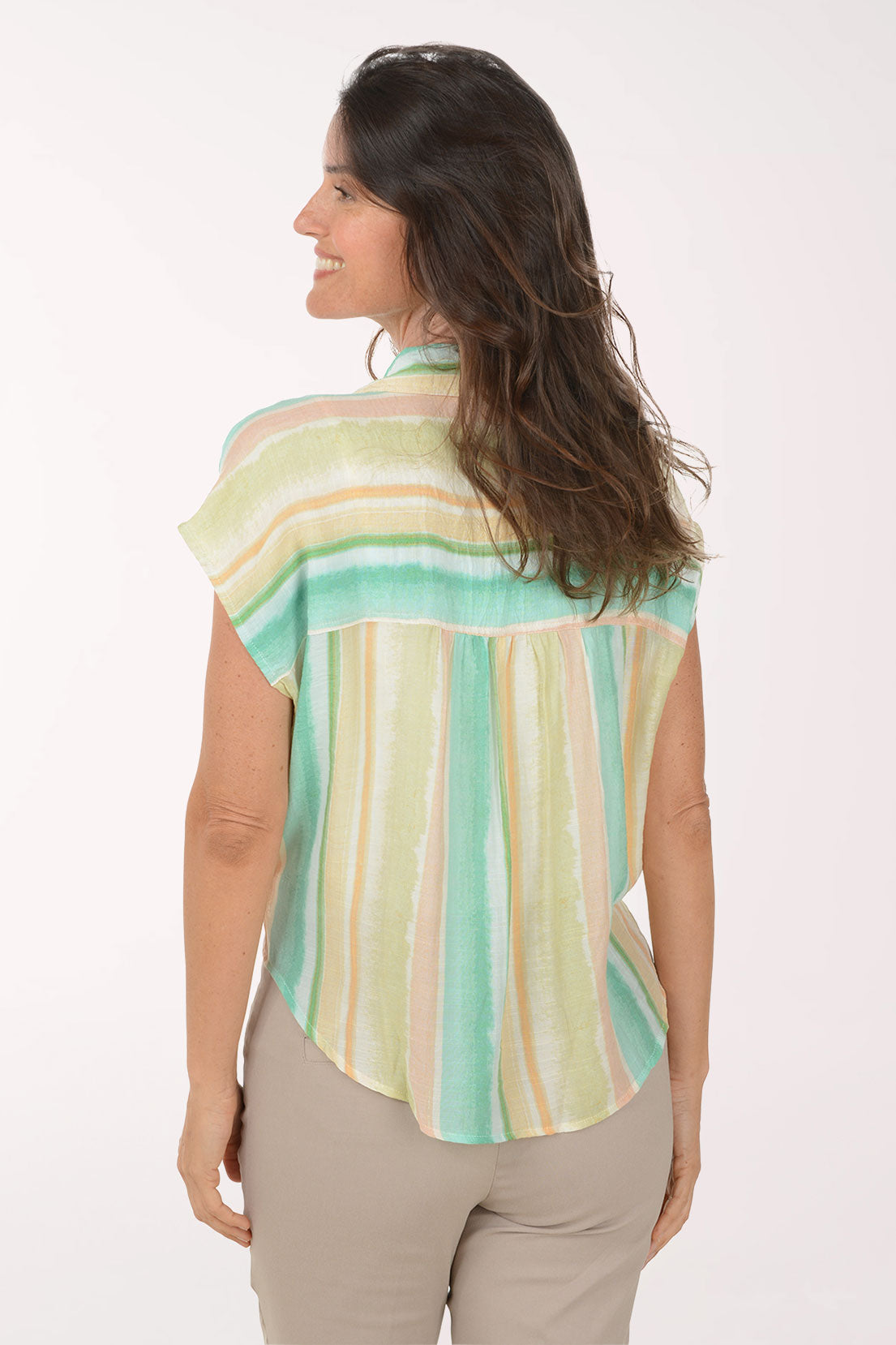 Woman wearing a colorful striped shirt with a white background
