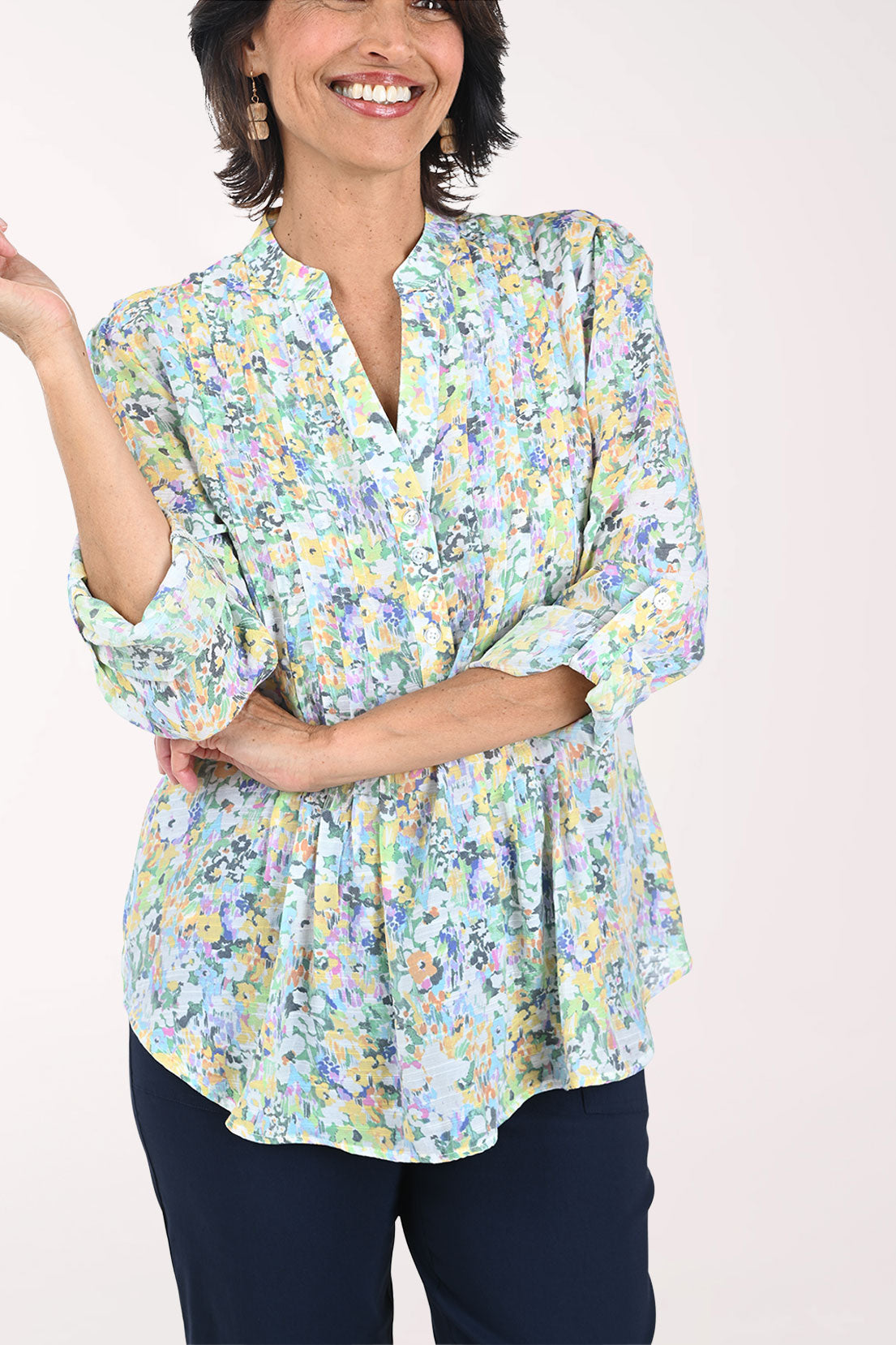 Woman wearing a floral blouse with a plain background