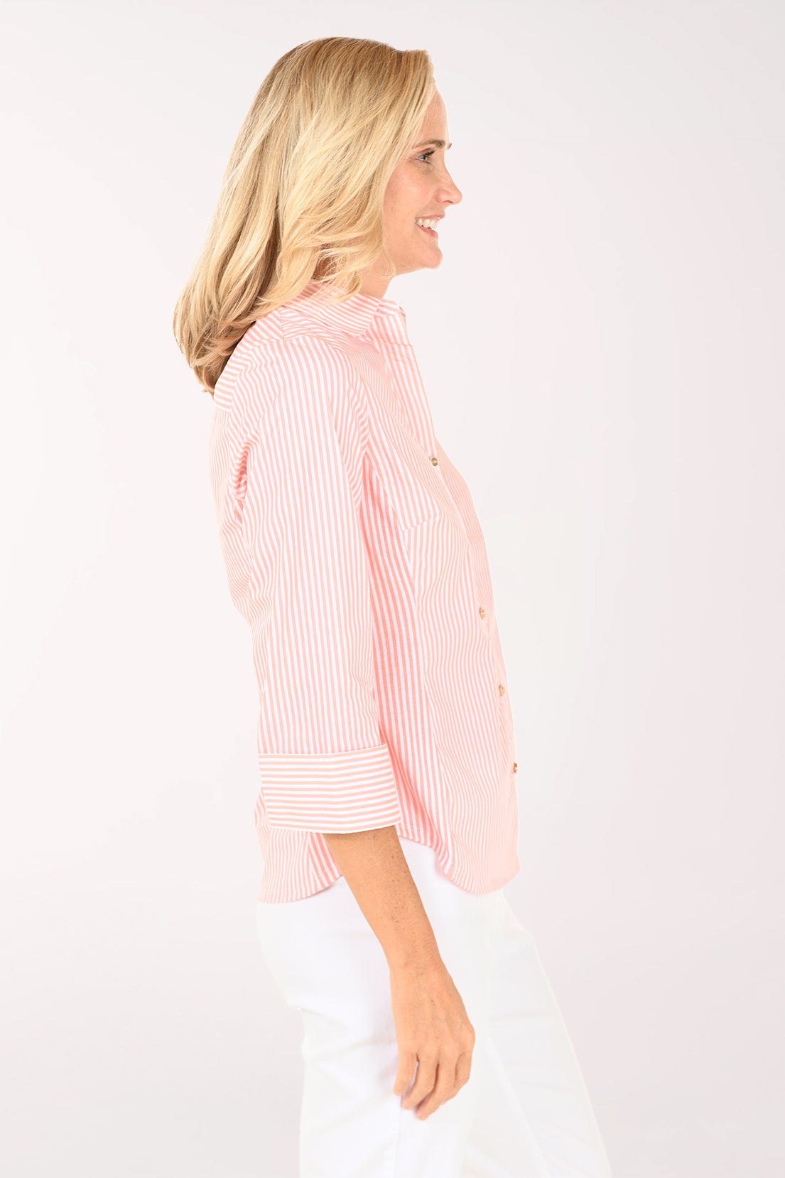 Woman wearing a pink striped shirt on a white background