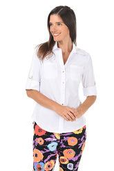 Woman wearing a white shirt and colorful floral pants on a white background