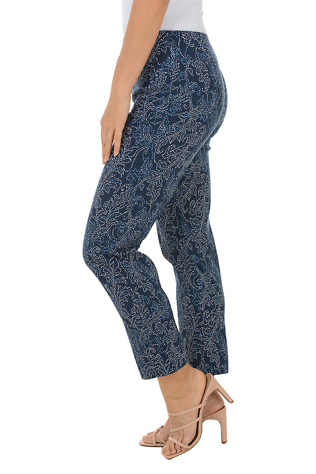 A side shot of a pair of pull-on ankle pants with a floral pattern, featuring an elasticized waistband, flat front and back, tummy control lining, and side slits on the hemline.