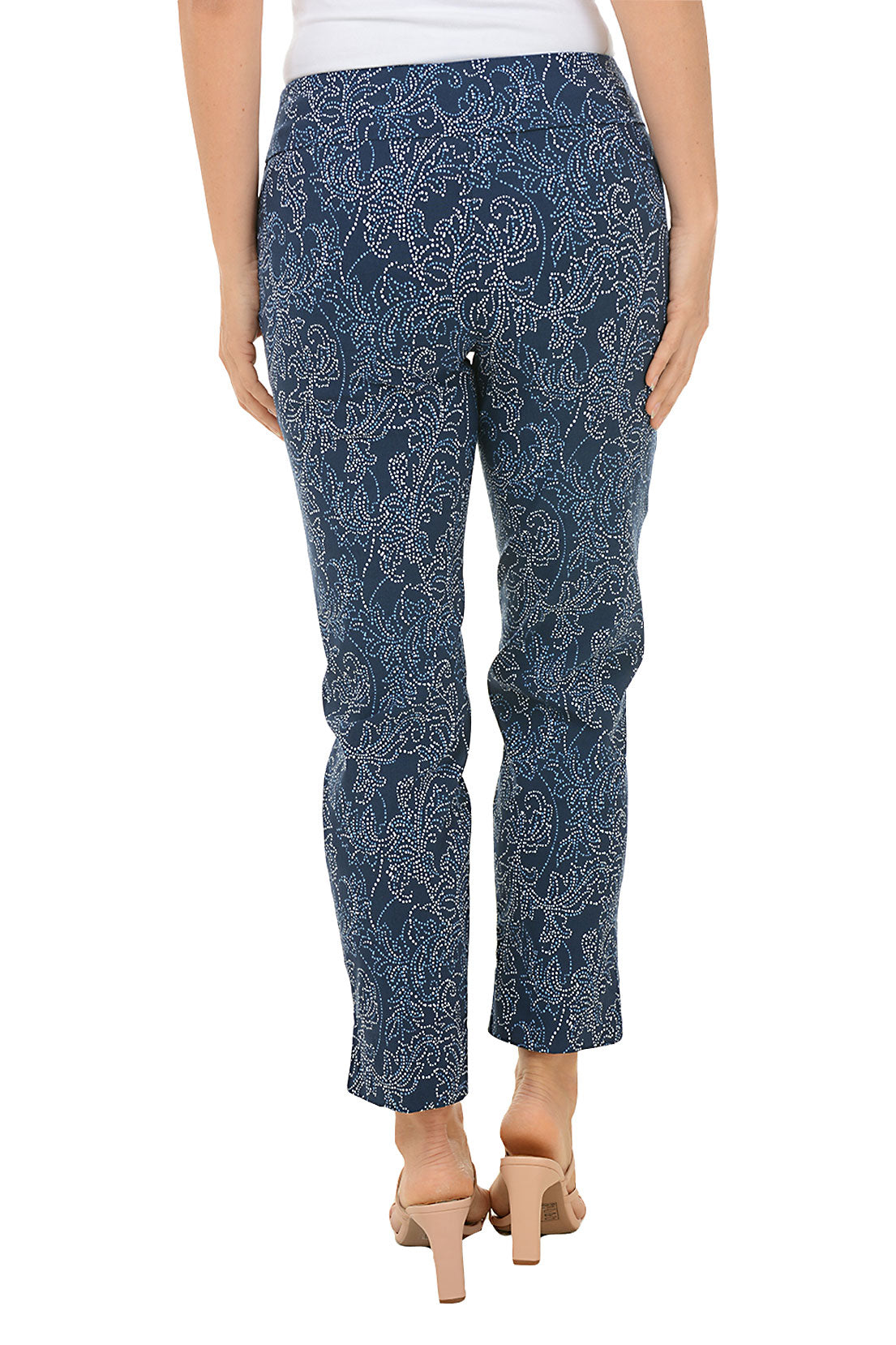 A back shot of a pair of pull-on ankle pants with a floral pattern, featuring an elasticized waistband, flat front and back, tummy control lining, and side slits on the hemline.