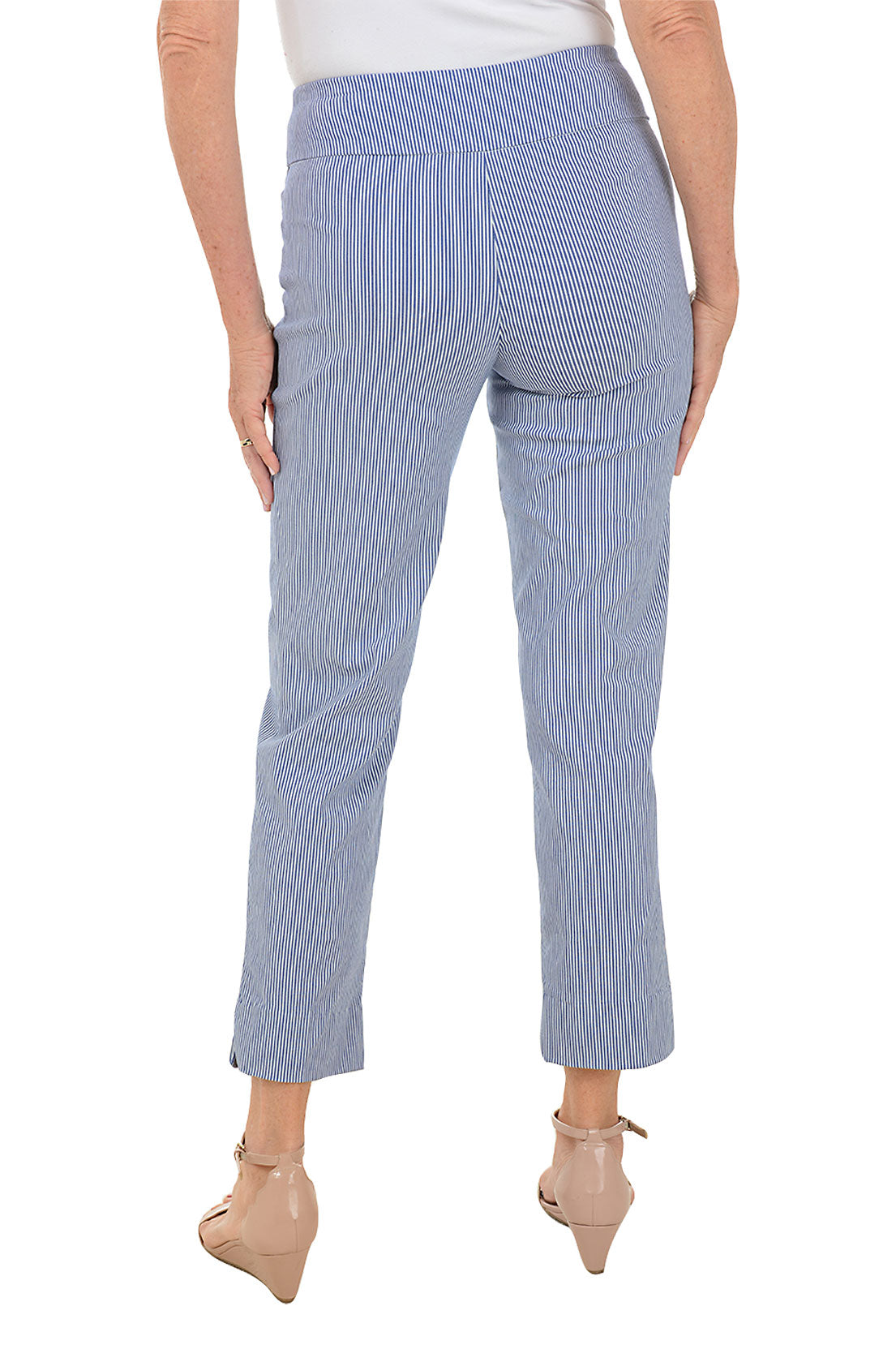 A back shot of a model wearing striped pull-on ankle pants in a blue color, standing against a plain background.