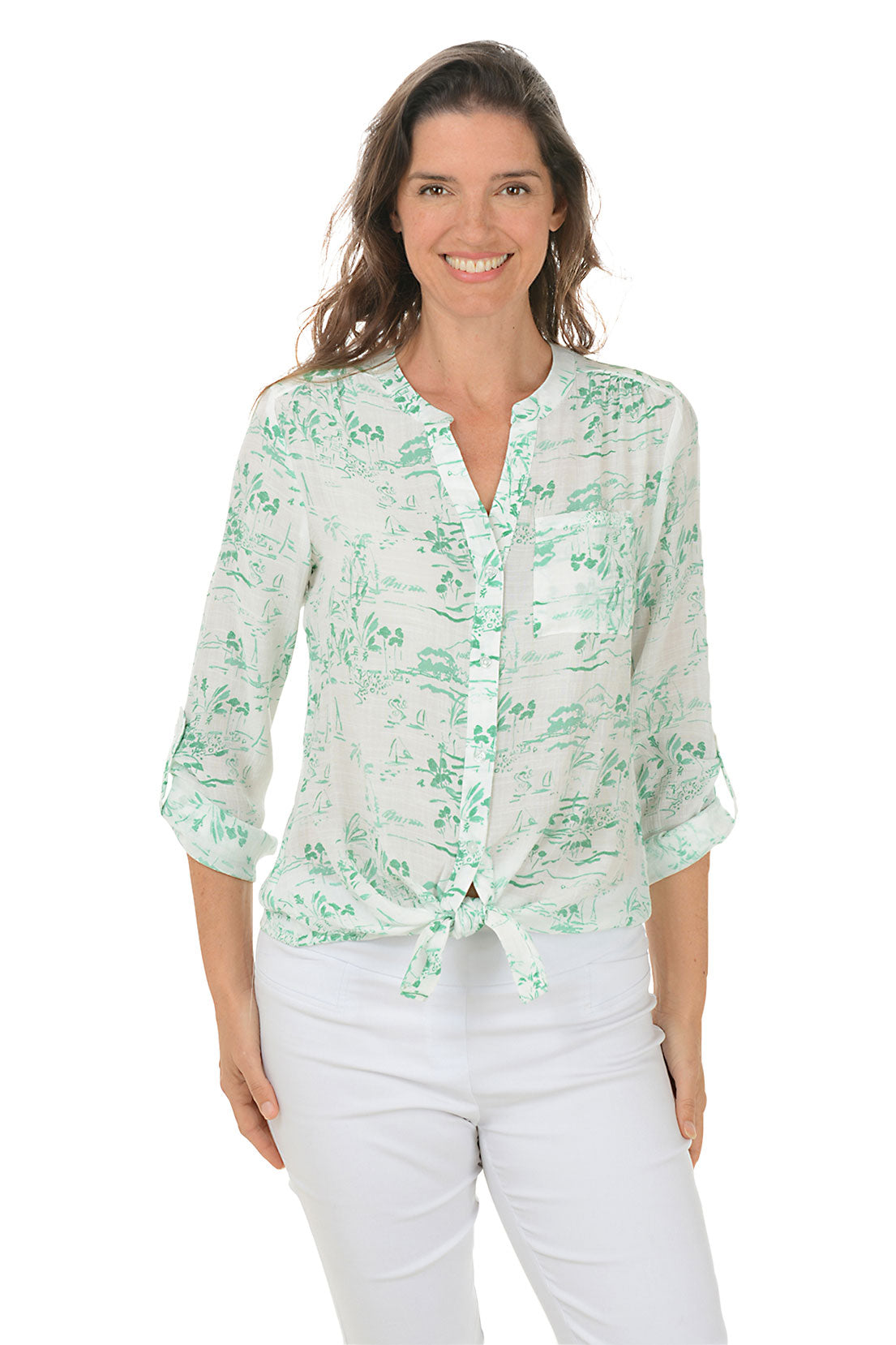 A front shot of a model wearing a green and white floral button-front blouse with a mandarin collar and long roll-tab sleeves, paired with white pants.