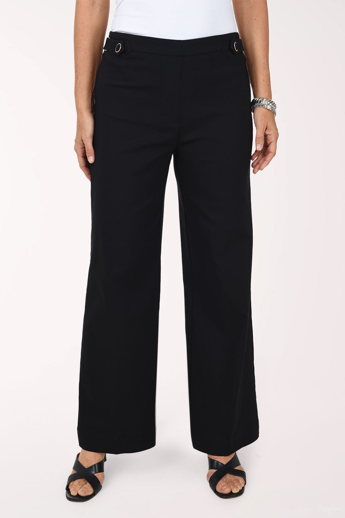 Front view of the Zac and Rachel Buckle Waist Wide Leg Pant in black, showing the buttoned buckle waistband and full-length wide leg with black sandals