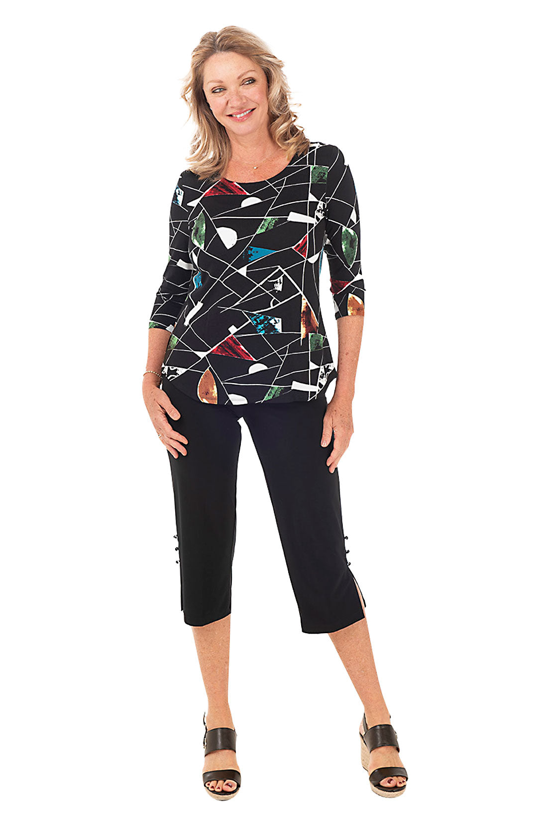 A model wearing black wide-leg capri pants with side button embellishments. Full length shot.