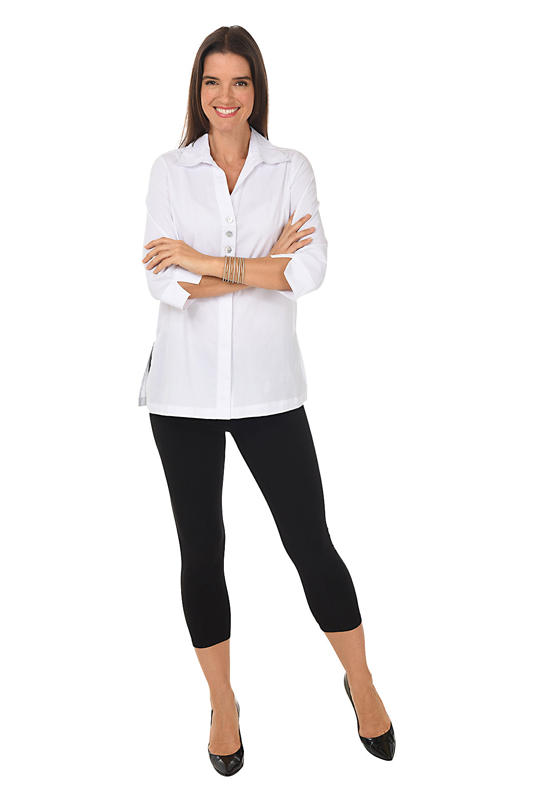 A woman wearing a cropped pair of black leggings with a bow detail on the back. Full length shot.