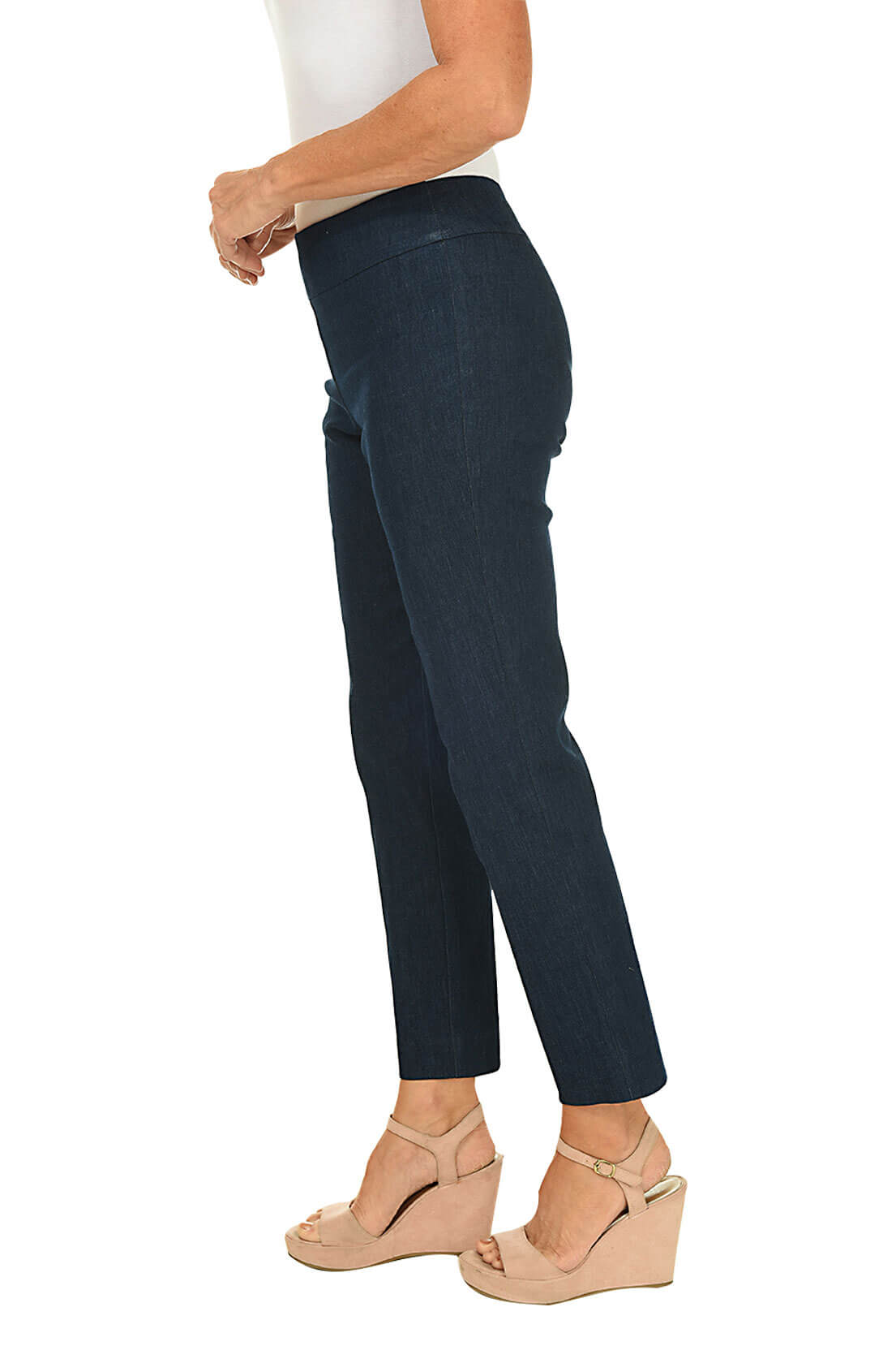 A side shot of a model wearing a blue denim pull-on ankle pant and a white top, beige wedges.