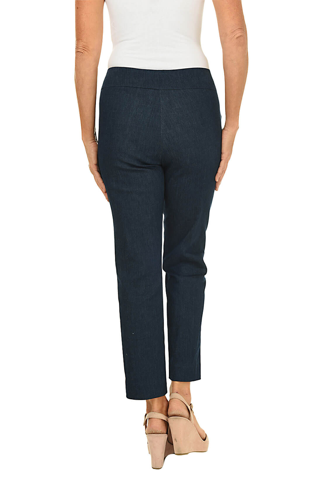 A back shot of a model wearing a blue denim pull-on ankle pant and a white top, beige wedges.