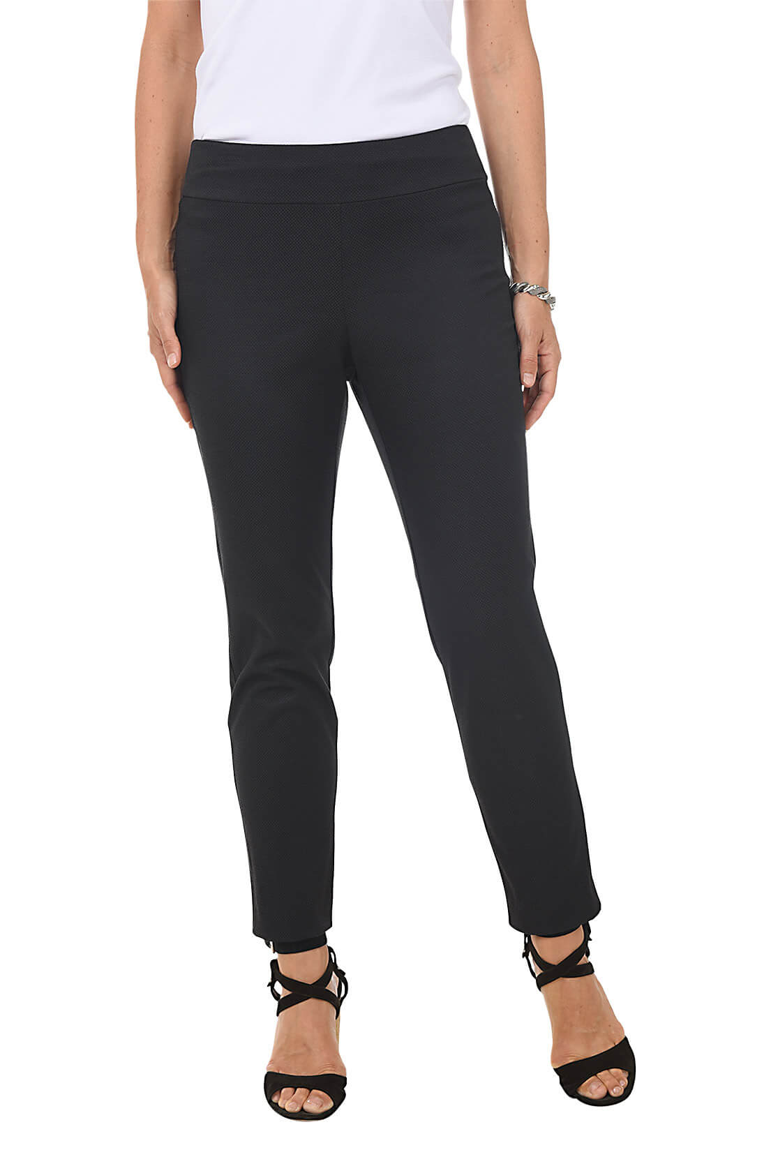 A front shot of a model wearing a pair of white textured pique pull-on ankle pants, with a slim fit and mid-rise waist.