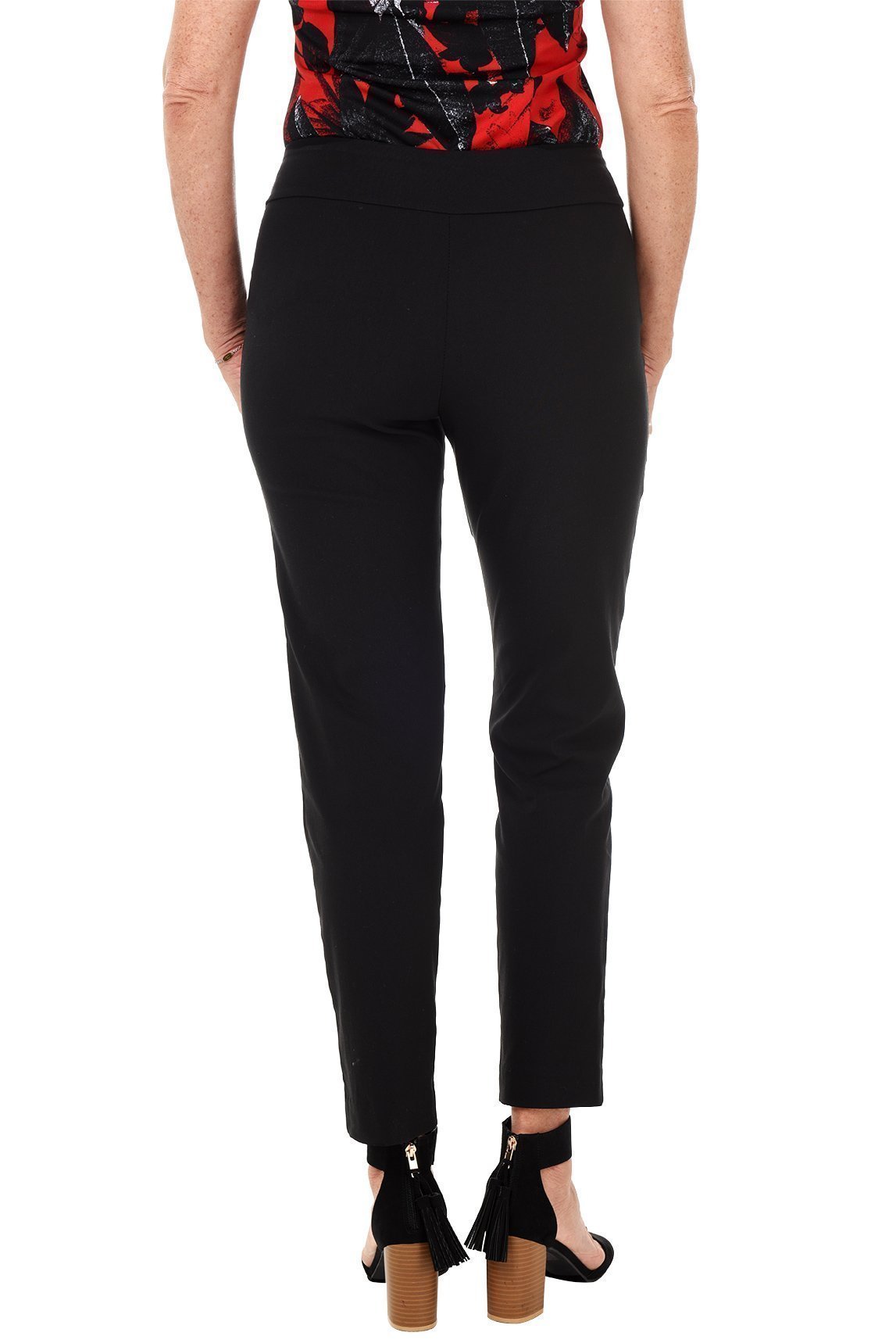 A back shot of a model wearing a pair of black classic pull-on ankle pants with a straight leg cut, displayed in a neutral shade.
