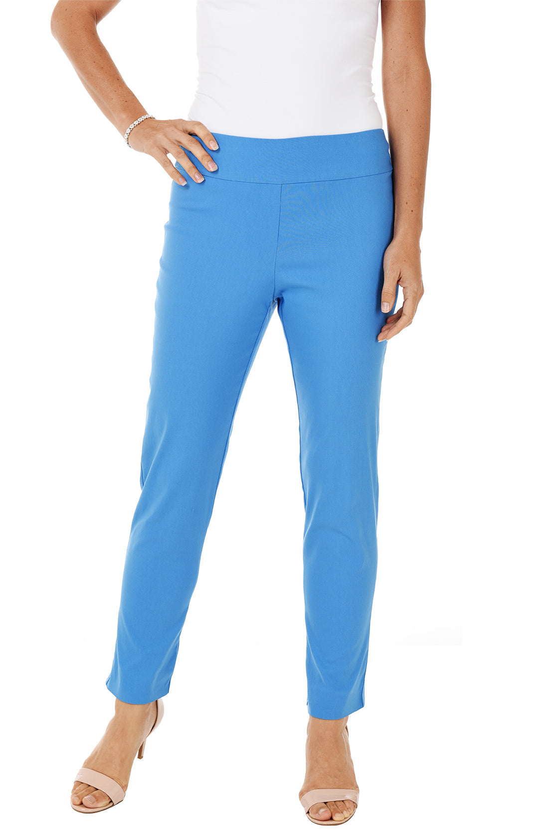 A front shot of a model wearing a blue pull-on ankle pant with a white top and beige wedges.