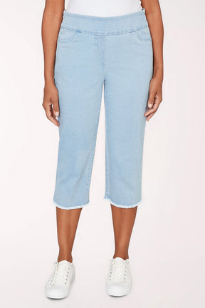 Woman wearing a light denim crop pant.