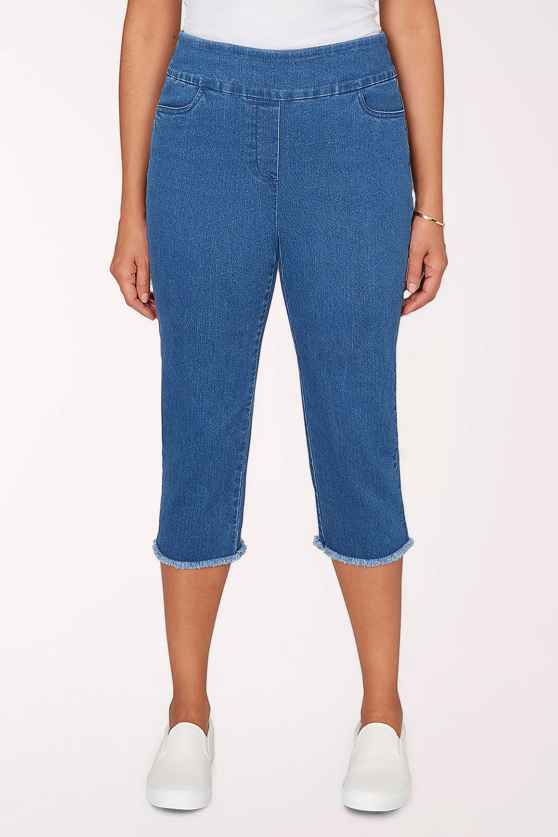 Woman wearing a medium denim crop pant.