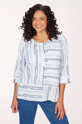 A woman wearing a blue multi 3/4 sleeve top.