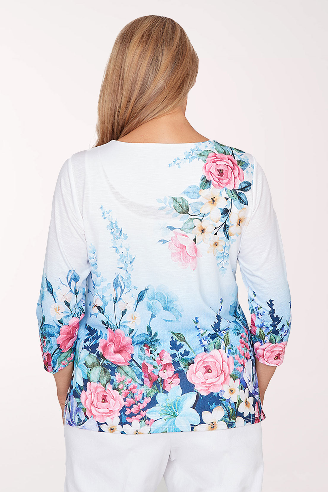 Woman wearing a floral blouse with a white background