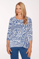Woman wearing a blue and white patterned top on a white background