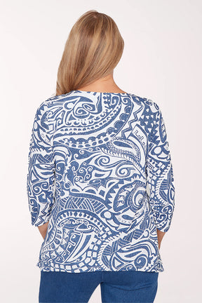 Woman wearing a blue and white patterned top on a white background